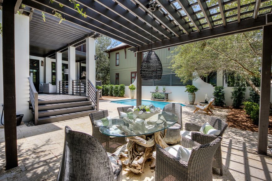 $225K + IN RENTAL PROJECTIONS! Located on a large corner homesite, this professionally decorated residence has it all. The spacious outdoor retreat includes a heated pool surrounded by fossil stone pavers, trellis, outdoor shower & covered porch with outdoor fireplace. Photographed for several magazines & design books, the home underwent renovations including a complete kitchen update. The gourmet kitchen has custom distressed wood cabinets, new appliances including a Sub Zero refrigerator, breakfast bar, & French doors that open out to the courtyard. The oversized master bedroom has its own porch, large walk-in closet & the bathroom includes Jerusalem limestone over 150 years old. There are two additional bedrooms on the second floor with ensuite bathrooms. The third floor, which is currently being used as a bedroom has a full bathroom & could easily become a second living area. The carriage home above the two car garage has a full kitchen, bedroom, bathroom & sitting area. Other interior selections include custom millwork, book cases & wood floors, Sonos system & wall covering from an original oyster shell photograph from an artist in New York that was made into wallpaper.  Close to all of the restaurants, shopping, & entertainment Rosemary Beach has to offer, this home is the perfect primary or vacation residence. Come view this unique & spectacular property today!
