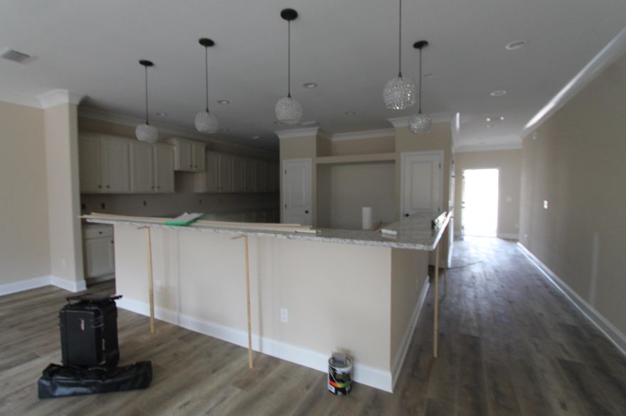 Introducing ''Temple Park at Port Dixie'', a 40 lot development is Shalimar with both underground utilities and broad sidewalks. 9th. Avenue offers wide streets, off street parking for visitors and guests, and homes with rear entry garages. This 4BR/4BA custom brick homesite consists of the main home being a 3/3 (2070 SF), then a separate 1/1(448 SF) cottage/ mother-in- law suite or game room with kitchenette, that is connected by a breezeway with courtyard. There are 10 Ft. ceilings w/ impressive crown molding, LVP flooring throughout most of the home, tile in the master bath, and 5 1/4'' baseboard throughout.