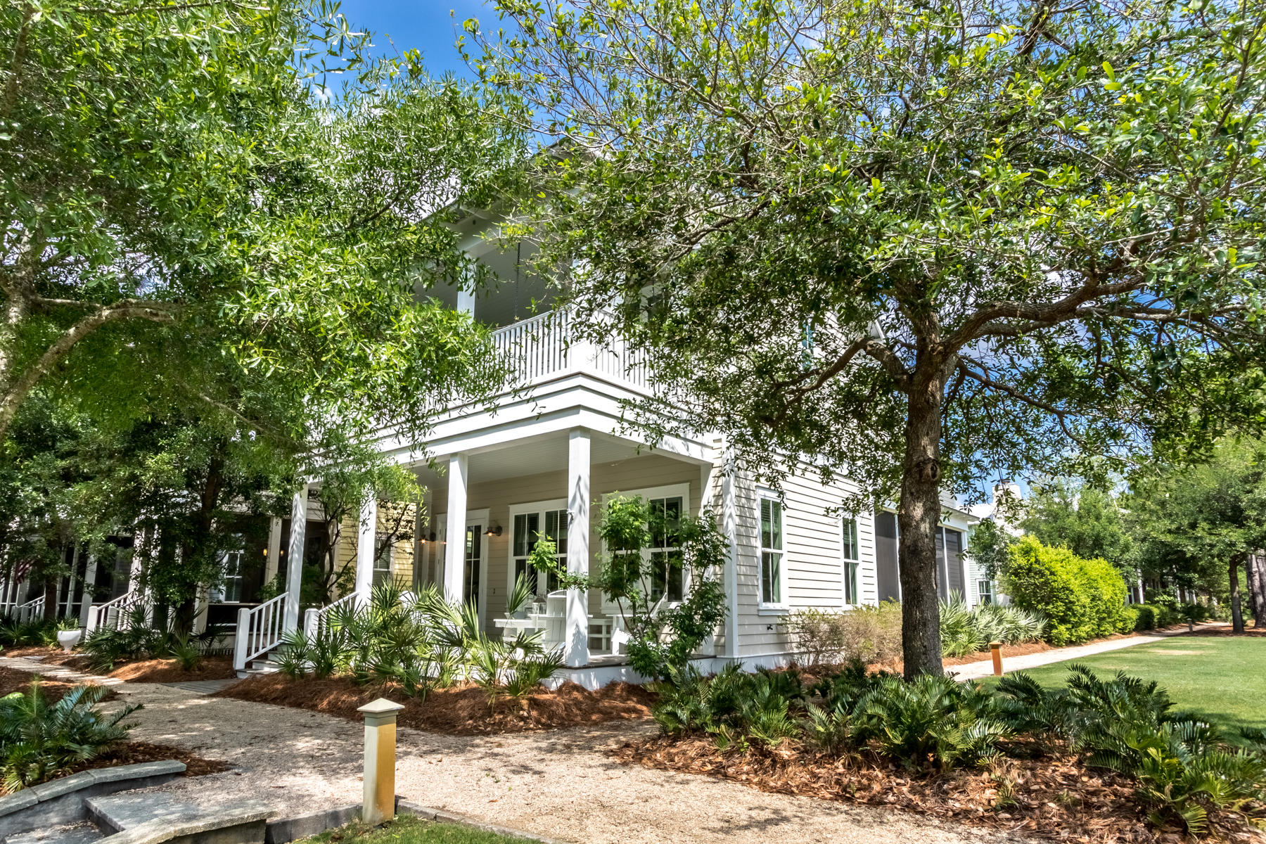 Ideally situated on Dragonfly Park, this beautiful Watercolor home features an open floor plan with abundant natural light and spacious porches. No details have been overlooked in this meticulously maintained and designer-furnished two story residence with golf cart garage. There are four bedrooms plus bunk room, four and a half bathrooms and the home is being offered mostly furnished. Features include upgraded oak hardwood floors throughout, a chef's kitchen with Thermador appliances and a beautiful bar area including a wine fridge. As you enter the home off the deep front porch, the open concept floor plan with large living room comes into view. From the dining room, French doors open onto a spacious screened-in porch with a TV and kegerator all overlooking the manicured park. The second