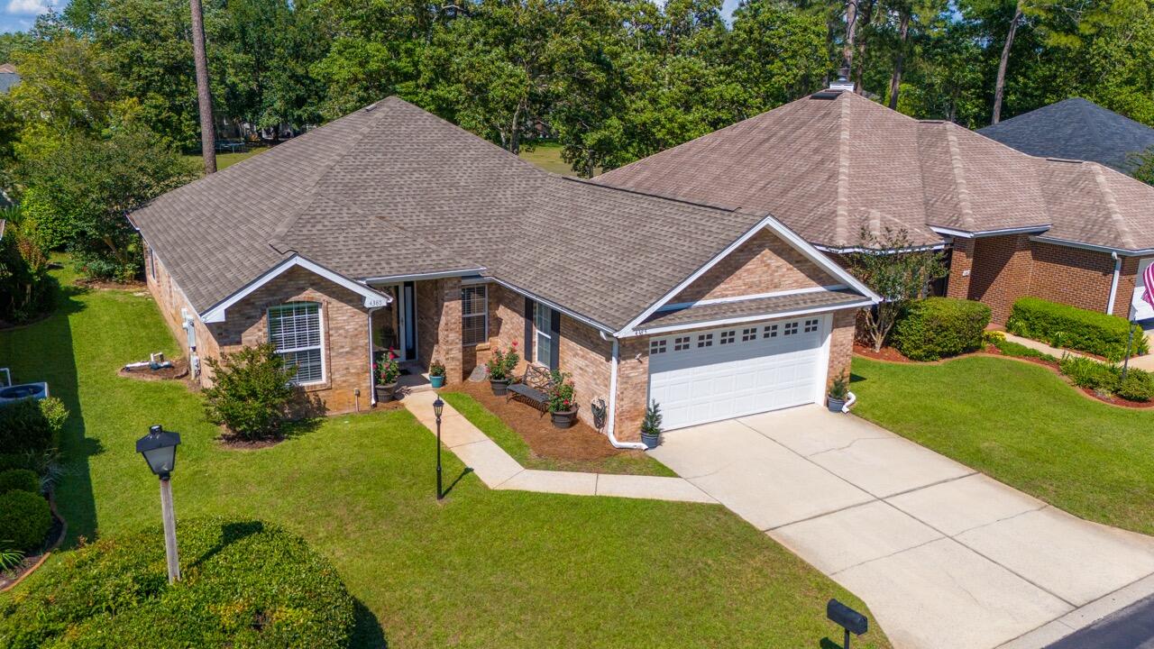 Welcome to your dream home in Bluewater Bay, Niceville, FL! Nestled in the serene subdivision of Millers Run, this charming one-story brick residence offers the perfect blend of comfort and style. With three spacious bedrooms and two full bathrooms, it's an ideal haven for families or those seeking ample space to spread out. Each bedroom boasts oversized closet space that allows for plenty of storage and the two car garage has attached cabinetry with a large countertop for projects as well as access to the large floored attic space! Step inside to discover a fresh and inviting atmosphere, thanks to recent updates that include fresh paint throughout the interior, lending a crisp and modern feel to every room. The newly installed tile flooring in the kitchen and hallway, leading into the laundry room, adds durability and a touch of elegance to high-traffic areas. The updated guest bathroom not only includes new tile flooring, but also impresses with new wall features and a beautiful new vanity! Prepare to be wowed by the newly renovated kitchen, a true culinary delight featuring sleek quartz countertops that offer both durability and timeless appeal. The pristine white shaker cabinets with gold handle accents not only provide ample storage but also exude a sense of sophistication. Completing the picture is a beautiful backsplash that adds custom texture, elevating the space to new heights of style complete with newer stainless steel appliances!
Outside, the property boasts freshly landscaped grounds with a large open field that expands off of the backyard. Located in the sought-after Bluewater Bay community, residents enjoy access to a wealth of amenities including golf, pickleball, tennis and the marina! Don't miss your chance to make this meticulously updated home yours - schedule a showing today and experience the epitome of Florida living in Bluewater Bay! *Chandelier in front entryway does not convey*
