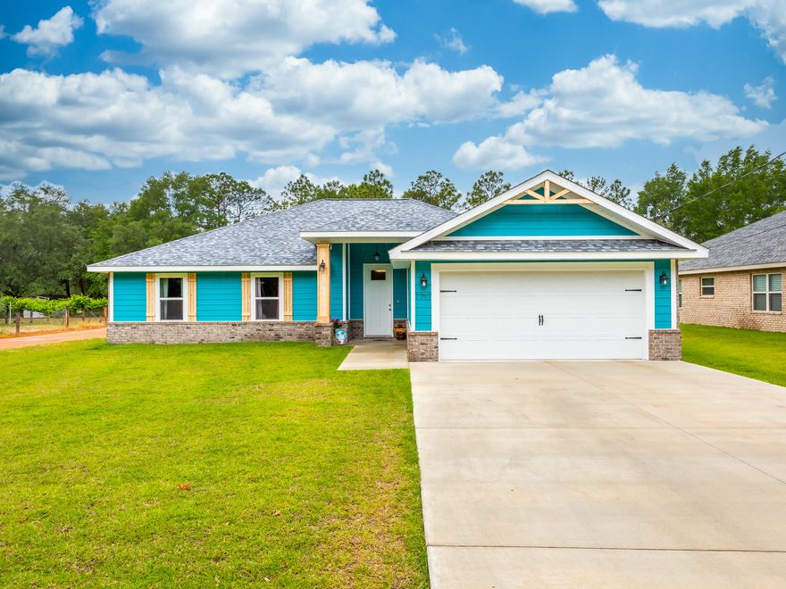 Located on the outer edge of Holley-Navarre, Vonnie Tolbert is an inviting and peaceful drive through beautiful trees leading up to this magnificent home. Welcome to your retreat located on a corner lot and directly across the street from the Eglin range. This home will provide you with all the space you need to entertain family and friends over the holidays or just for a casual get together. With 4 well sized bedrooms, 2 baths, and a beautifully arranged open floor plan, the opportunities are endless. Custom wainscoting wraps both areas to create a cohesive, inviting environment. This culinary oasis is complete with all wood cabinetry, full overlay shaker doors, soft close doors/drawers, granite counter-tops, beautiful back splash and stainless steel appliances. The master bedroom is beautifully covered with a tray ceiling, an accent wall, walk-in closet with multi-level shelves, and a shoe rack.  The master bath features granite counter-tops, a linen closet, a custom tiled shower with an extra-large niche including a glass shower enclosure.  Luxury vinyl plank flooring throughout the home.  French doors will lead you out to your covered porch where bird watching will become your new favorite pastime as you enjoy watching Blue Jays, Cardinals, and Hawks from your very own woodland setting.  The ceiling fan on the porch will make sure you are comfortable on those warm, Florida days as you take in the surrounding nature.  There's plenty of room for parking in your over-sized two car garage (26' x 20') that includes space for ATVs, motorcycles, etc..  The garage also showcases a utility sink and pull-down stairs leading to the attic. The wider driveway (40' x 20') and garage have the added benefit of allowing comfortable parking for larger vehicles. The backyard has a privacy fence and double, drive through gate.  A recently installed shed (approximately 12' x 8' with loft - no power) is a great addition in the backyard for extra storage or projects.  Exterior details:  siding is hardie board front with brick on side and back.  25 year asphalt, dimensional shingles.  14 Seer Heat Pump.  Full sod and sprinkler system.  You will also be able to experience outdoor adventures such as biking, camping, fishing, and hiking along the Florida Hiking Trail located just feet away from this amazing property! Away from the hustle and bustle of highway 98, this could be your sanctuary at the end of the day. With quick access to highway 87, there is no need to worry about being too far away from necessities. Quick and easy access to Navarre Beach, shopping and restaurants are approximately 10 minutes away.  A favorite local hotspot (Ye Olde Brothers Restaurant and Brewery) is right around the corner.  Interstate 10 is right up the road approximately 10 minutes to the North.   A few additional words to describe this great property:  quiet ~ lots of woods ~ private ~ No HOA.  Don't miss out on the opportunity to make this your new home!  
