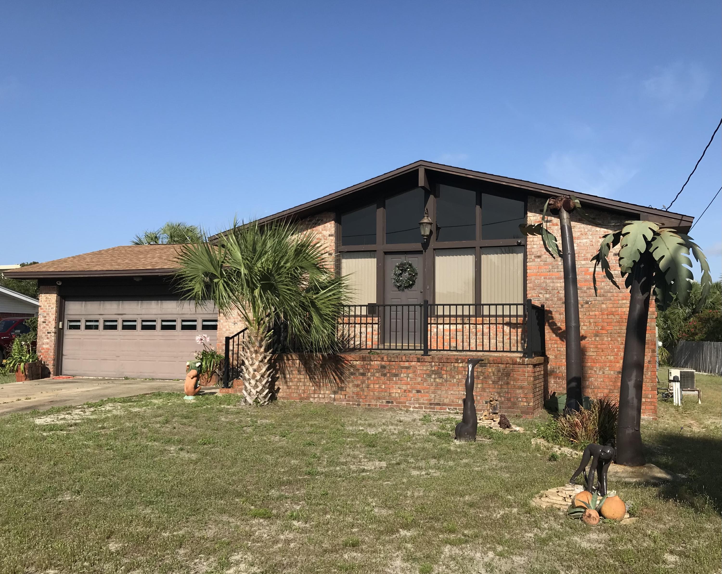 PRICE REDUCED! PRIMARY RESIDENCE OR SECOND HOME! Large lot on Okaloosa Island. Walk to the beach! This home is situated between two public beach accesses within a two to five minute walk! Brick home with BRAND NEW HVAC JUST INSTALLED 05/21! Upgraded with granite countertops in kitchen and bath, as well as stainless steel appliances. The spacious living area features lots of windows for natural light, a vaulted ceiling and wood burning brick fireplace. Master bedroom and bathroom convenient to kitchen and eating area which includes a sliding glass door access to patio and back yard large enough for a pool! Two bedrooms and large bathroom with two sinks off the hallway. Two car garage with door opener (new motor). Home Warranty! New rust resistant railing on front porch where you