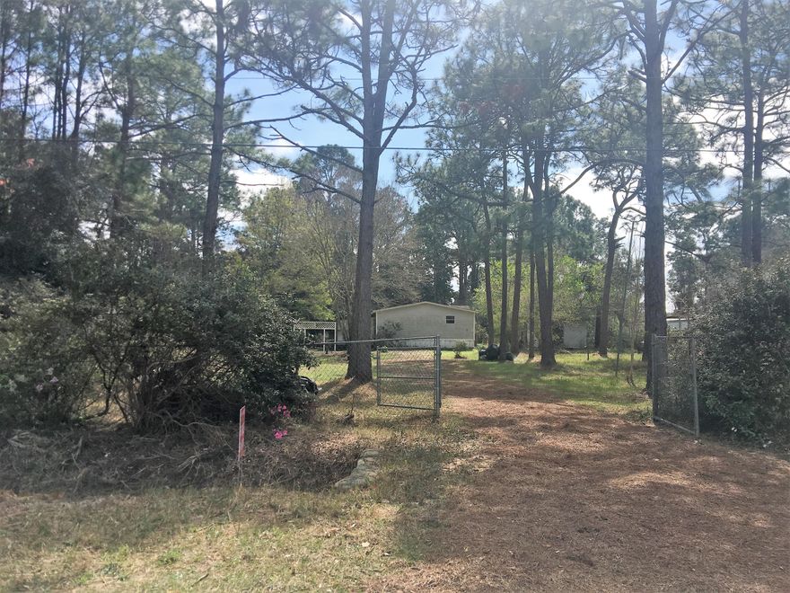 Over 2 acre lot that could be your own private paradise. This lot is fenced on three sides with the fourth side bordered by a creek. There is a 100X40 block garage with concrete floor and plumbed for an apartment. The ceilings in the shop are high. The lot has two gated entrances and has a well on the property. There is also an additional storage building. There is currently a mobile home on the property so all tap fees have been paid, however, no value is given to the mobile home. There are also fruit trees on the property. New construction is going up on the street behind the property with newer homes just built on Eagle Nest. Buyer to verify all information.