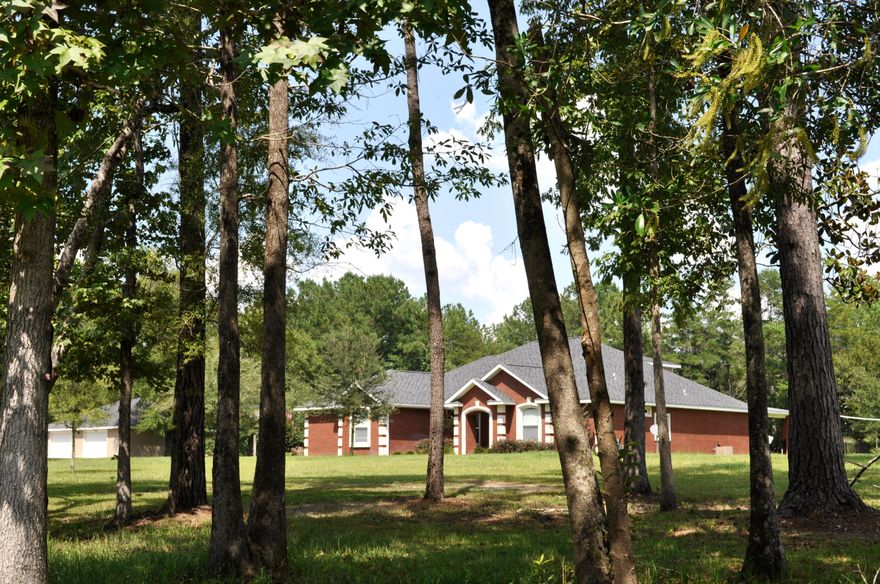 Every box will be checked on your wish list...there's simply no detail left undone. This quintessential family home is built to the highest of standards, with custom features throughout. This one owner 5 bed/ 3.5 bath pool home is contractor owned and built. Out in the country, yet just 5 minutes to DeFuniak Springs. Not a neighbor in sight on 2.5 acres with the option to add even more. The floorplan lends itself to total functionality. The kitchen's custom maple cabinets, granite countertops and breakfast bar, and walk in pantry has sweeping views of the family room, florida room, and the pool! The 3 kids' bedrooms are on one side & mom and dad are comfortably set up on the other side in the luxurious master retreat. The 5th bed (or could be used as a den) is upstairs. There's a dedicated