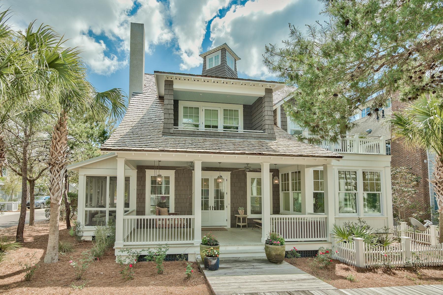 Situated on a large corner lot, meander onto the boardwalk in front, walk in the woods out back, and in under four minutes on foot, you can have your toes in the sand on the luscious pearl white sand beach. This wonderful home comfortably blends timeless sophistication with eternal simplicity. It's a splash of Nantucket tucked into a luxurious WaterSound setting. The front porch beckons one sit for a spell, and the open concept interior calls for fun times and magnificent entertaining. An elegant, contemporary kitchen and dining nook are flooded with natural daylight, with more dining space at the breakfast bar and dining table. A large gas range, double ovens, marble and granite counters, stainless steel appliances and a farmhouse sink are complemented with a butler's pantry for prep work