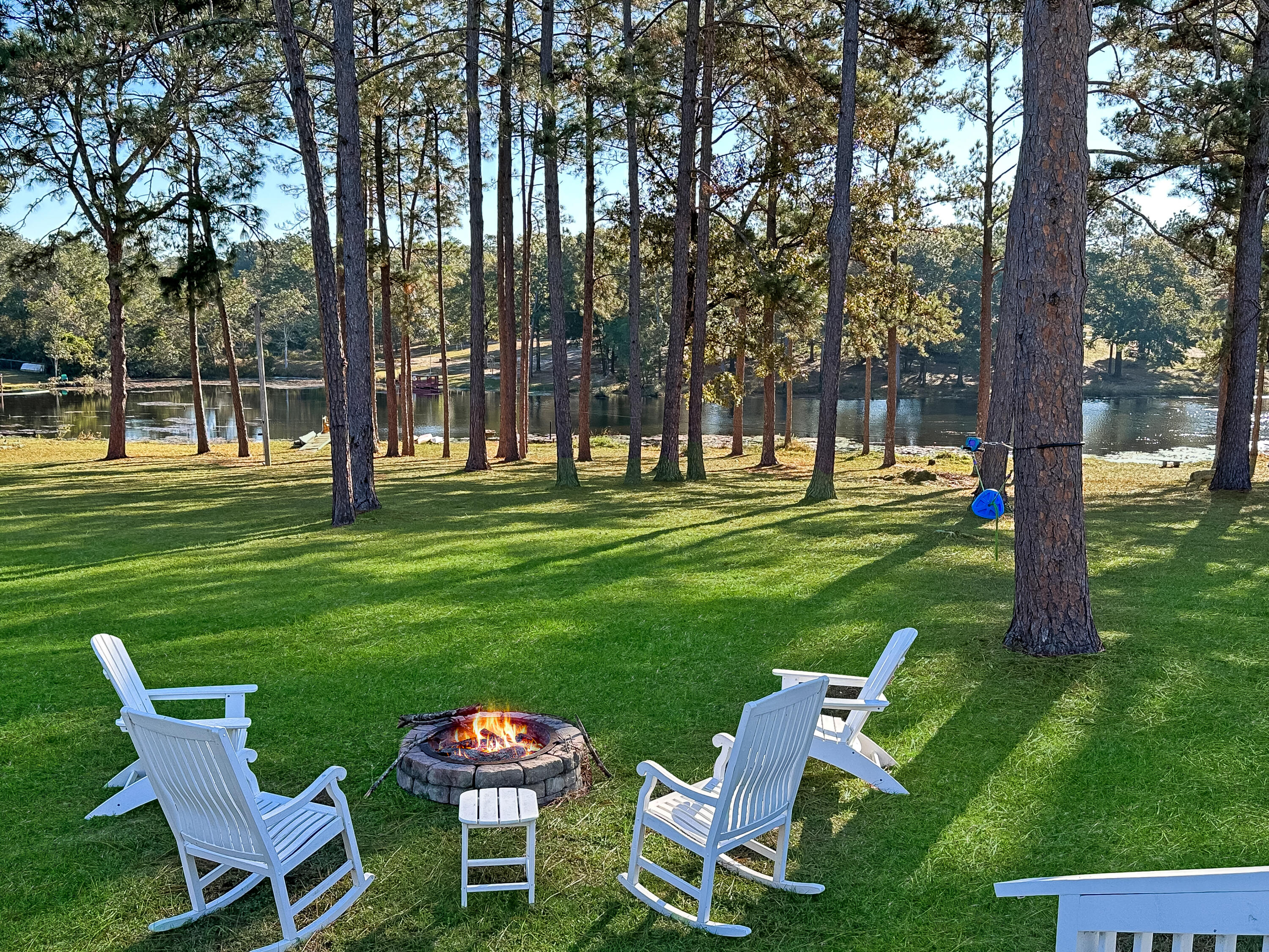 Waterfront with flat green park like setting! Just like a relaxing Resort! Dock, fishing, deer, geese, enjoyable fire-pit, feed the turtles! WOW, now is the time to act! This treasure just hit the market and you can be in by Christmas or sooner! Dream the day away on the comfy spring loaded porch swing!  Roomy porch/carport use your imagination for all the options! Top of the line features such as granite kitchen with Island/peninsula! Stainless steel appliances, soft close drawers! AC heat pump new in 2015! Long lasting Metal roof! Newer laminate floors and Luxury vinyl! Upgraded thick ceiling insulation 2021 for a cozier feel and saves money!