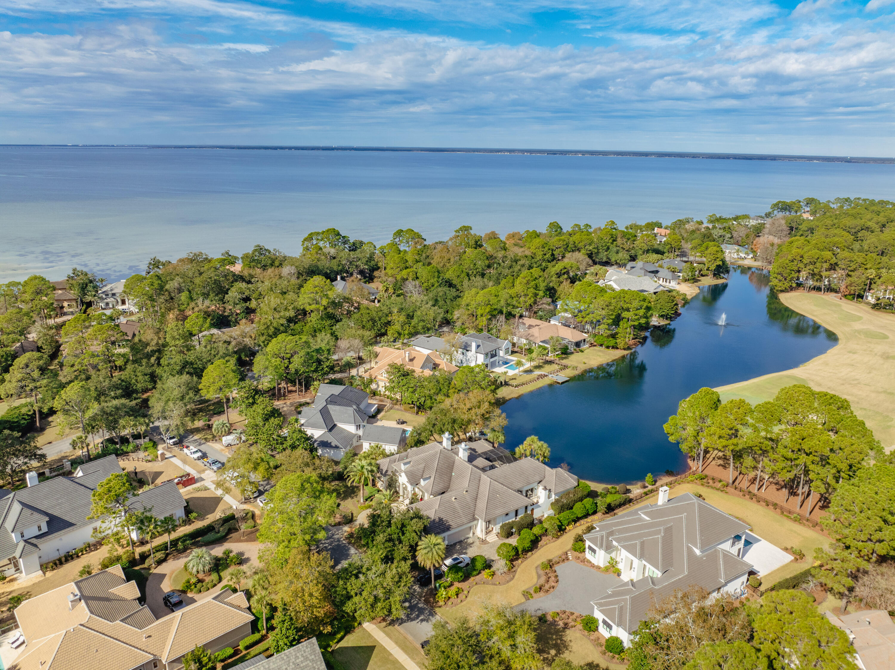 ''Luxurious Lakefront Living in Burnt Pine'' Stunning Architectural Masterpiece in Burnt Pine: Welcome to this breathtaking 4-bedroom, 4-bath home in beautiful Burnt Pine. This architectural gem boasts expansive living areas filled with natural light, offering an unparalleled flow for modern living. Grand Entrance & Elegant Interiors: Step through the mahogany front doors into a dramatic foyer adorned with Travertine, Limestone, and Brazilian Walnut floors, accented with intricate mosaics. The living room, one of five spaces featuring custom mantels and columns, exudes warmth and sophistication. Luxurious Great Room & Chef's Kitchen: The soaring great room seamlessly connects to the gourmet kitchen, equipped with Thermador appliances, including a double convection oven and warming drawer. Overlooking the enclosed pool, lake, and golf course, this space is perfect for both intimate gatherings and grand entertaining. Master Suite Retreat: The master suite is a private sanctuary, featuring a spacious bedroom with a cozy fireplace, a luxurious en-suite bathroom with a soaking tub, walk-in shower, and dual vanities, as well as a large walk-in closet with custom built-ins. This serene space offers the perfect escape at the end of the day. Outdoor Oasis: The outdoor living area is a true retreat, featuring a summer kitchen, heated pool, hot tub, and a stunning mosaic water fountain with a fire bowl. The vast space is ideal for dining and entertaining, offering breathtaking views of the lake. Versatile Bonus Room & Custom Features: The bonus room, currently media and sports memorabilia showcase, can easily transform into a library, pool room, or formal living room. Most closets feature custom built-ins, and a dehumidification system ensures the home's longevity in Florida's humid climate. Ample Storage & Modern Conveniences: With optimal storage in every room, including walk-in attic access for seasonal items, and a three-car garage with extensive storage options, this home combines luxury with practicality. The Lutron lighting system allows for customized ambiance, and new attic-accessible HVACs are being installed for ease of service. Comfortable Elegance: Despite its grand scale and lavish attention to detail, this home offers a comfortable elegance, perfect for both grand entertaining and everyday family living.

As an introduction to the Sandestin lifestyle, we invite our new owners to explore amenities that make Sandestin special. The listing brokerage and seller(s) are presenting the buyer(s) of this property with (2) 90-minute rounds of Tennis court time, a golf foursome at one of our three championship courses, and a round of golf for up to four (4) players at the unrivaled Burnt Pine Golf Club.

Sandestin Golf and Beach Resort features more than seven miles of beaches and pristine bay front, four championship golf courses, 15 world-class tennis courts, a 226-slip marina, a fitness center, spa and celebrity chef dining. Shop, dine and play at the charming pedestrian village, The Village of Baytowne Wharf and more. Inside the gates of the resort, residents enjoy a balanced lifestyle of high-class living, spanning the 2,400 acres from the beach to the bay. Everything within the gates of the resort is accessible by golf cart or bicycle. The entire resort is interconnected by miles of pedestrian, bike and golf cart paths that weave through groves of live oaks, meandering past natural lagoons, fountains, man-made lakes, and meticulously landscaped fairways.

