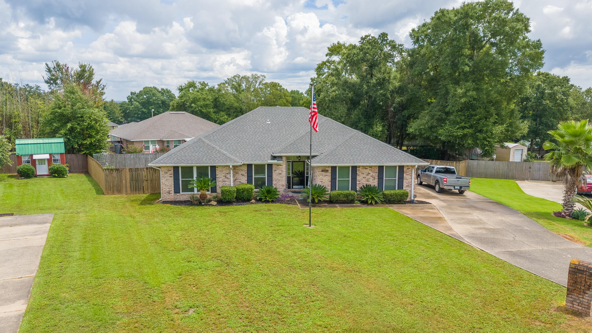Well-kept 4-sided brick home on a quiet cul-de-sac with no HOA, sitting on a half-acre lot. Beautiful landscaping, fenced backyard with pergola, brick fireplace, fire pit, screened patio, and gated access for boat/RV parking. Inside features a versatile front bedroom/office, spacious living room with wood-burning fireplace, and kitchen with stainless appliances, convection oven, open pass-through, and dining area overlooking the yard. Master suite offers cherry wood floors, double vanities, garden tub, and walk-in closet. $25K storm-rated windows throughout. Solar panels keep power bills near $30/month -- seller will pay off $40K balance at closing with right offer. Minutes to boat launches, 15 miles to Blackwater River State Park, less than 8 miles to NAS Whiting Field, 24 miles to NAS Pensacola, close to shopping, dining, medical facilities, Pensacola Airport, and Gulf Coast beaches.