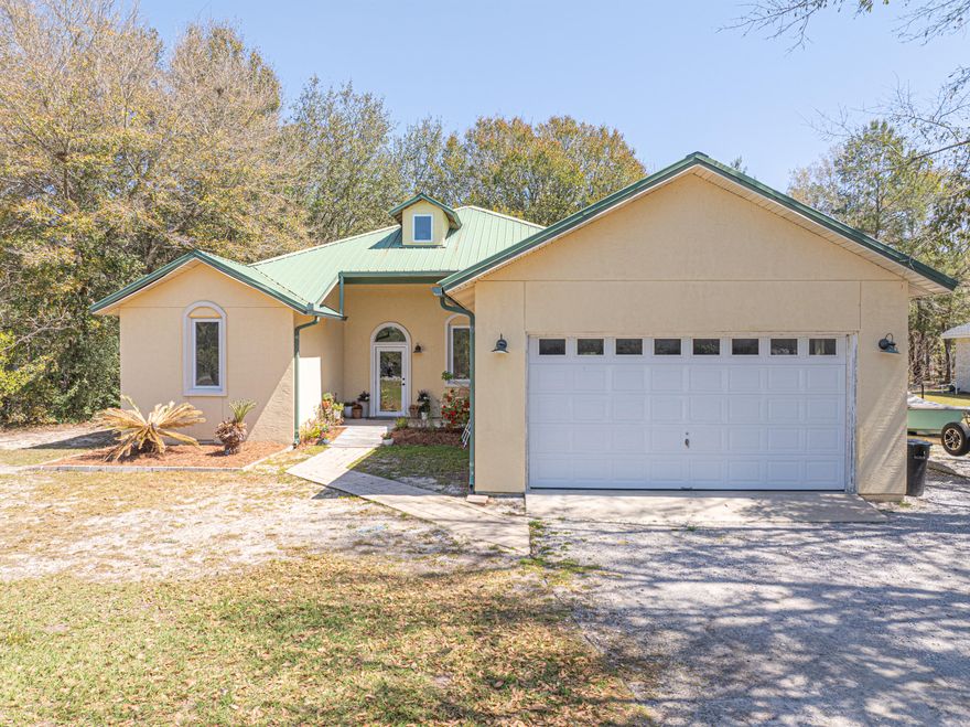 Your search for tranquil living is over! Welcome to your 3-bedroom 2-bathroom home with a large garage on a beautiful 0.46 acre lot. This residence features a bright and open concept layout, flooding the space with natural light and creating an inviting atmosphere perfect for relaxation and entertaining. The spacious living area flows effortlessly into the dining area and kitchen, making it ideal for family gatherings. Retreat to the  master bedroom, featuring a generously sized walk-in closet and an en suite bathroom that is truly a highlight of the home. The master en suite includes a relaxing soaking tub and a tiled walk-in shower, providing a perfect escape for unwinding. The two guest bedrooms are spacious, and there is a guest bathroom with walk-in shower. On the second floor, you'll find a large bonus room with endless potential! This versatile space can easily be transformed into a fourth bedroom, home office, movie room, or gym, accommodating your lifestyle needs.

Enjoy the serenity of your screened-in patio, a perfect spot to soak in the fresh air without disturbances, whether you're enjoying morning coffee or unwinding in the evening.

The oversized 2-car garage allows for easy parking and additional storage for your tools or recreational gear. Set on a 0.46 acre lot, you'll have plenty of space to cultivate your own outdoor paradise. This property features a brand new electric tankless water heater, ensuring energy-efficient and on-demand hot water for all your household needs.

This non HOA, private community has a dedicated boat launch allowing you to enjoy the beauty of nature on Black Creek which leads to the Choctawhatchee Bay. Located in Freeport, just 5-10 minutes away from shopping, restaurants, and schools. The white sugar sand beaches of 30A are a 20-minute drive away!

This home offers a perfect blend of peaceful living and easy access to water activities. Don't miss out on this opportunityschedule your viewing today!