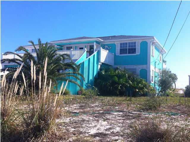 Fantastic Income potential for this Navarre Beach Home! Two separate living quarters, upstairs is main house with large great room, kitchen, breakfast nook, 3 bedrooms, 2 baths, owners lock out closet and two expansive decks, one gulf side, one sound side. Downstairs there's a large newly renovated kitchen with stainless steel appliances, living room, two bedrooms and one bath, another huge deck facing the gulf side, and large deck on the sound side. There's a covered area for parking, a cozy gazebo and Tiki Bar for entertaining, and laundry room to service both up and down units, a large storage area/workshop and plenty of parking! This home is currently owner occupied, but in the past has been a great income producer on the summer rental program. The views are fabulous. The