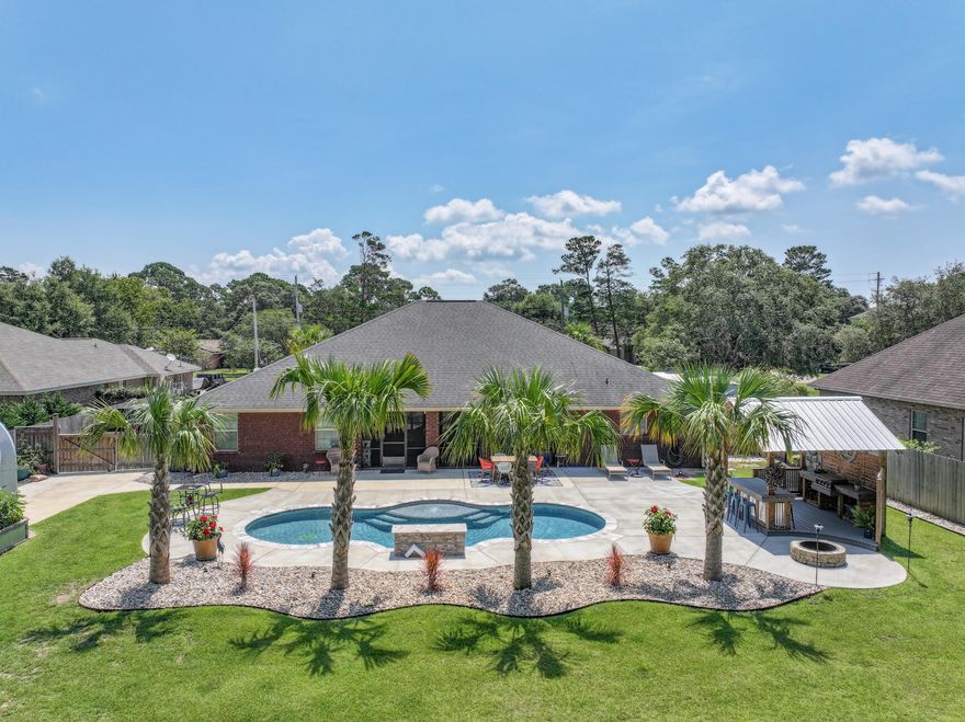 Welcome to 2911 Paso De Vivoz in Navarre where the beach life meets a little bit of country life. This remarkable listing offers a multitude of enticing features that make it a truly exceptional property. Experience the seamless integration of indoor and outdoor living with our large kitchen and living room that open to the expansive screened porch. Also the indoor and outdoor kitchen offers an ideal setting for hosting memorable gatherings and preparing delicious feasts while enjoying the company of your loved ones. The primary suite is perfect space for privacy and comfort. Enjoy the perfect blend of relaxation and recreation with the stunning pool that awaits you in the backyard. The landscaping and yard lighting is unbelievably gorgeous.