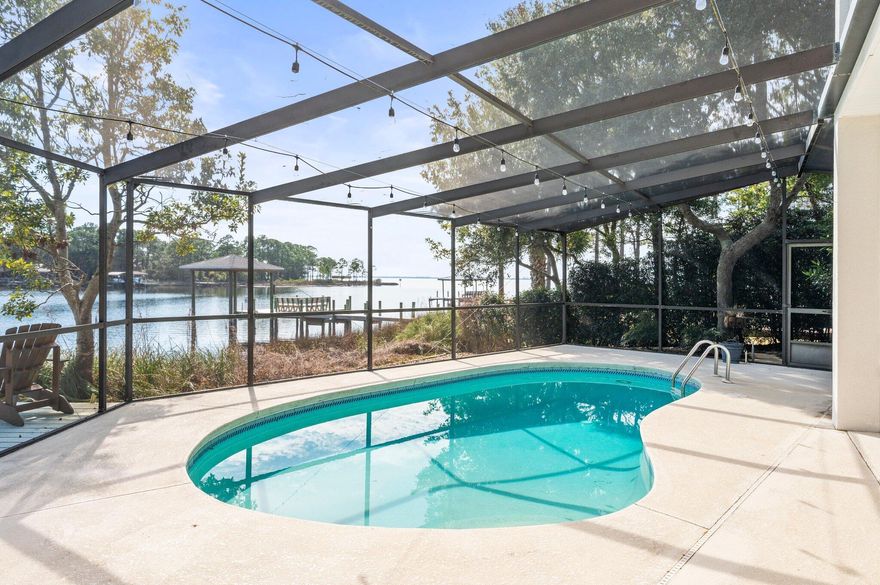 HUGE PRICE IMPROVEMENT!! Claim your piece of paradise with this spectacular WATERFRONT HOME cloistered within the gates of Bluewater Bay's Southwind community. 4400 Windlake Drive is an extraordinary property, positioned perfectly to enjoy both SUNRISE and SUNSET along PROTECTED Grass Lake with immediate access to Choctawhatchee Bay. From the wide and welcoming foyer with soaring ceilings and dramatic staircase to the open concept kitchen, dining, and living space beyond, the water remains on center stage. Find expansive water views from nearly every room in the home including all four bedrooms! Refresh in the POOL, dine alfresco, or host a party inside the generously sized screen enclosed pool deck also overlooking Grass Lake. Relax and unwind around the fire pit just outside the screen enclosure or wander to the thoughtfully redesigned dock and boat house (2019) for a breathtaking, immersive wildlife experience as dolphins, manatees, schools of fish, waterfowl, osprey, bald eagles, and even a family of otters play! Indoors, this home exceeds expectations in terms of functionality, flexibility, comfort, and style. Boasting over 3,500 square feet of living space, an oversized 2-car garage with a tandem golf cart extension, and multiple walk-in attic storage areas, discover a place for everything and everything in its place.  In addition to the living, dining, and kitchen area at the heart of the home, the main floor also features a formal dining room currently used as an office, a cozy family room with gas fireplace, a laundry/utility room with work sink and ample storage, a stylish half bathroom, a super functional flex room currently used as a home gym, and a serene primary bedroom suite with access to the pool enclosure. The second floor offers three spacious bedrooms, one full bathroom, a bonus room with direct access to one of two attic storage spaces, and a covered balcony overlooking the water and accessible from two bedrooms. 
4400 Windlake Drive represents a special opportunity to own a waterfront pool home in gated Southwind, one of Bluewater Bay's most desirable communities. Take full advantage of all that Bluewater Bay resort has to offer including golf, tennis, pickleball, pools (separate fees/memberships available for all these amenities), miles of recreational trails, a marina complex and boat ramp, restaurants, shopping, health care, and more are all within easy reach. Zoned for Bluewater Elementary School, with a choice of Destin or Ruckel Middle School, and Niceville High School. Whether by boat or car, arrive quickly and easily across Choctawhatchee Bay and enjoy the Emerald Coast's world-famous white sand beaches, entertainment, shopping, and more in Destin and 30A.

