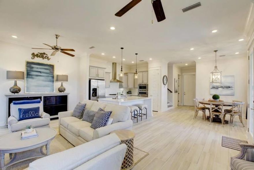 The Largest and ONLY Bahamas Triplex unit available in Prominence! Designer lighting, coastal finishes boasting 3 bedrooms with a 2 car garage, open back deck, Fully Furnished and turnkey with rentals on the books to transfer. Updated features to include 10ft ceilings, quartz counters, hardwood floors, open equipped kitchen and upgraded appliances. Comfortably accomodates 10 people with a Master, Guest Bedroom, double built in Bunks and Queen sleeper.Located just across 30A from The HUB where you will find shops, restaurants and an ampitheater covered pavilion for movies, music and events. This is your next beach investment; won't last long!