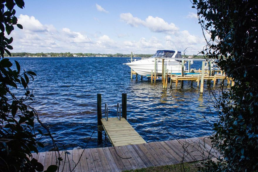 You don't want to miss this one! Incredible Water front views from every floor. If you want waterfront living-THIS IS WHAT YOU WANT. DEEP WATER BOAT SLIP INCLUDED. When you walk in from your foyer you see a bedroom or a game room straight ahead of you. Garage-yes, Your garage is to your right and stairs that lead upstairs are to your left. You have a full bath down stairs with plenty of storage. Large sliding glass doors that lead out to your covered deck-WITH UNOBSTRUCTED VIEWS OF GARNIERS BAYOU. On the second level you have an open floor plan with large sliding glass doors that lead out to another large covered deck over looking the bayou. Family room with a dining area and kitchen. All open-you can see the water from every room. Large open kitchen with stainless steel appliances. There is a half bath also on this floor. On the third floor is the Master, you have fantastic views from your bedroom with sliding glass doors that lead out to another covered deck. Glass french doors are what separates the bedroom from the master bath. The master bath has a double vanity, large walk in shower and a large walk in closet. There is another bedroom on this level with it's own bath. THIS IS WHAT PEOPLE DREAM OF WHEN THEY TALK ABOUT WATERFRONT LIVING WITH A BOAT!!!! This complex is small, close to everything but tucked away to provide the seclusion you want in a home. Check this unit out today