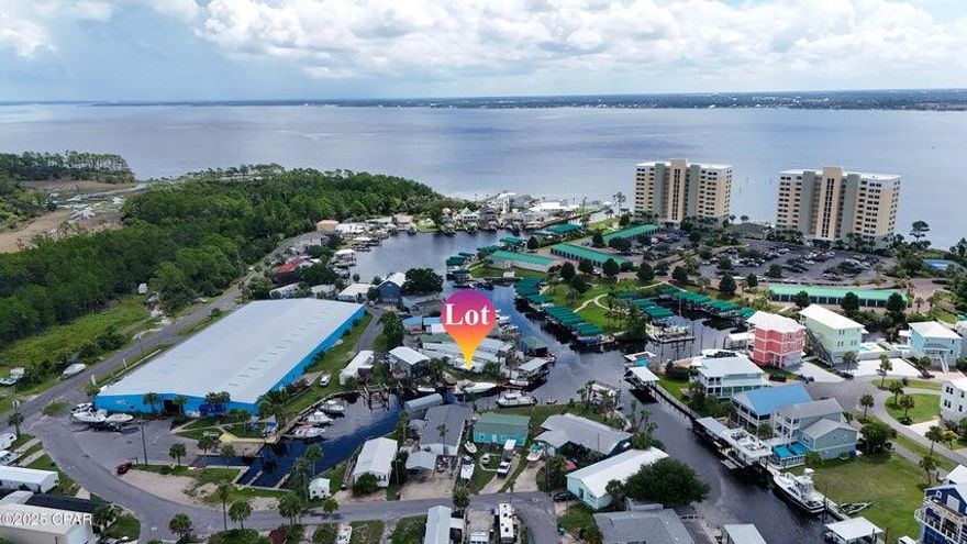 Waterfront Lot, Boat Slips, Deep water, rare find on Panama City Beach! This one-of-a-kind waterfront lot offers deep water access and two private boat slips, including one with a lift--perfect for keeping your boat in your own backyard. Whether you're ready to build your dream waterfront home, a second home, or a vacation rental, this property offers unmatched flexibility with no HOA restrictions. Currently has a 40 foot SeaRay docked in the back to give a perspective on the size boat and will host an even larger boat if needed! Located on the East End of Panama City Beach, you're close to shopping, restaurants, entertainment, and the Navy Base. Pier Park is just a few miles away for even more dining and attractions, or if peace and quiet is what you seek, simply sit on the dock and watch the boats cruise by. Next door is a full-service marina with a boat ramp, and you're just a short ride to the Hathaway Bridge, Shell Island, the Gulf, or your favorite waterfront restaurant. A small RV currently sits on the property and can stay or be removedyour choice. There's nothing else like it on the beach. Bring your sandals and live the salt life!