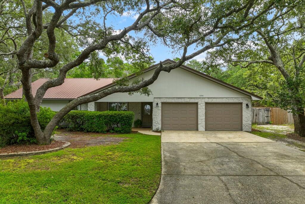Welcome to this thoughtfully renovated 4 bedroom, 2 bath home with a two car garage located in the desirable Bluewater Bay area. Interior features include newer LVP flooring in main living areas, carpet in bedrooms, Brushed Nickel Fixtures, Granite Countertops & stainless appliances. The spacious great room has a wood burning fireplace and is adjoined by a beautiful Florida room that opens up to a large privacy fenced in back yard. There is plenty of room for entertaining! This home backs up to a reservation and offers a ton of exterior yard space. Convenient to all things Niceville and just a short ride to Destin over the Mid Bay Bridge. BWB also offers a pool convenient to members for a fee! Pets allowed with a non-refundable pet fee. No smoking or vaping