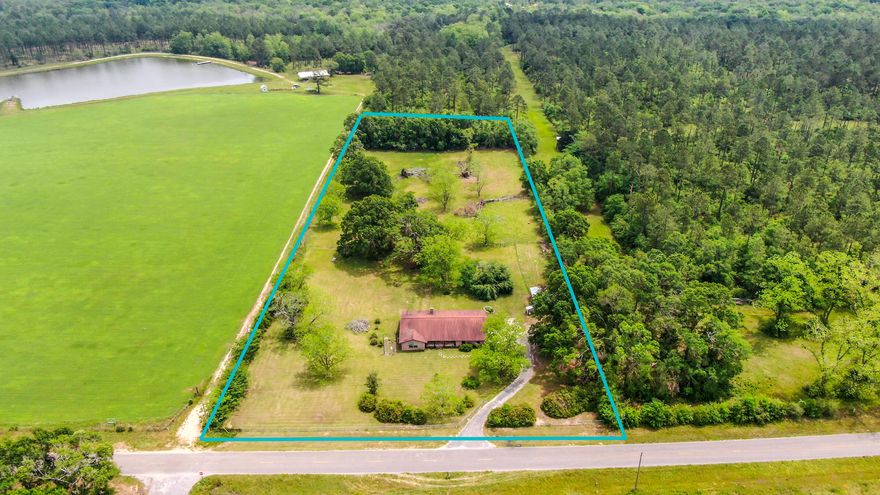 This 3 Bed/3 Full Bath ranch-style farmhouse on 5 lush acres is in an idyllic rural setting, 10-15 min to both DeFuniak Spgs & Paxton. Stunning property, loaded with stately pecan trees, a giant huckleberry tree, pole barn w/ fenced area & surrounded by large acreage parcels. It's been beautifully updated & with so many separate spaces inside, there's room for everyone. The family room, Florida room & living room could double as office, playroom, etc. Lots of possibilities. The kitchen features granite counters, SS appliances & breakfast bar. The family room has a large, wood burning brick fireplace. New laminate flooring throughout. There's a charming mudroom off the kitchen & 2-car garage, which leads into the oversized utility room/pantry space w/ a 3rd full bath. Country life awaits!