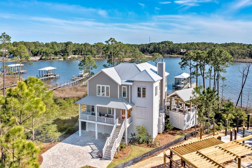 Great sunset views beautiful bay views on this waterfront retreat. Situated on  Hogtown Bayou with 119 feet of waterfront footage. Open floor plan with a spacious chef's kitchen, vaulted ceilings, reclaimed solid wood beams and gas wood-burning fireplace. 5 bedrooms, 3 full bathrooms and 1 half bathroom.  Great for entertaining family and guests. The chef's kitchen features a Thermador gas range, Thermador 36' built-in refrigeration, farm-house sink, quartzite natural stone countertops and a walk-in pantry with microwave and beverage fridge.  This is the ideal first home or great investment opportunity.