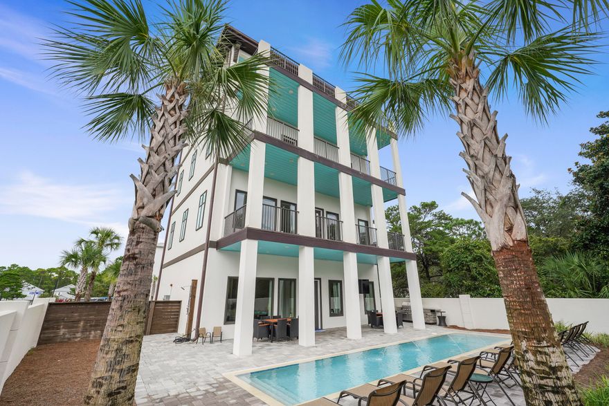 MOTIVATED SELLER! A once in a lifetime opportunity to own your own small resort with deeded beach access and GULF VIEWS! There is nothing like this home on the market right now so it will not last long!  Have you been looking for an income producing machine, a 2nd home for the entire extended family, or even the envy of the panhandle to retire? With 7 bedrooms, 7 baths, and over 5300 sq ft of resort style luxury your search is over now! Projected to Gross 380K this massive vacation rental sleeps 30+. Completely renovated this concrete fortress offers a heated resort pool and outdoor kitchen, an elevator to all 4 floors, multiple laundry rooms, a kitchen with a butlers gully, game room, multiple living areas, balconies on all floors, and an exercise room. All of this for under 600 sq. ft.