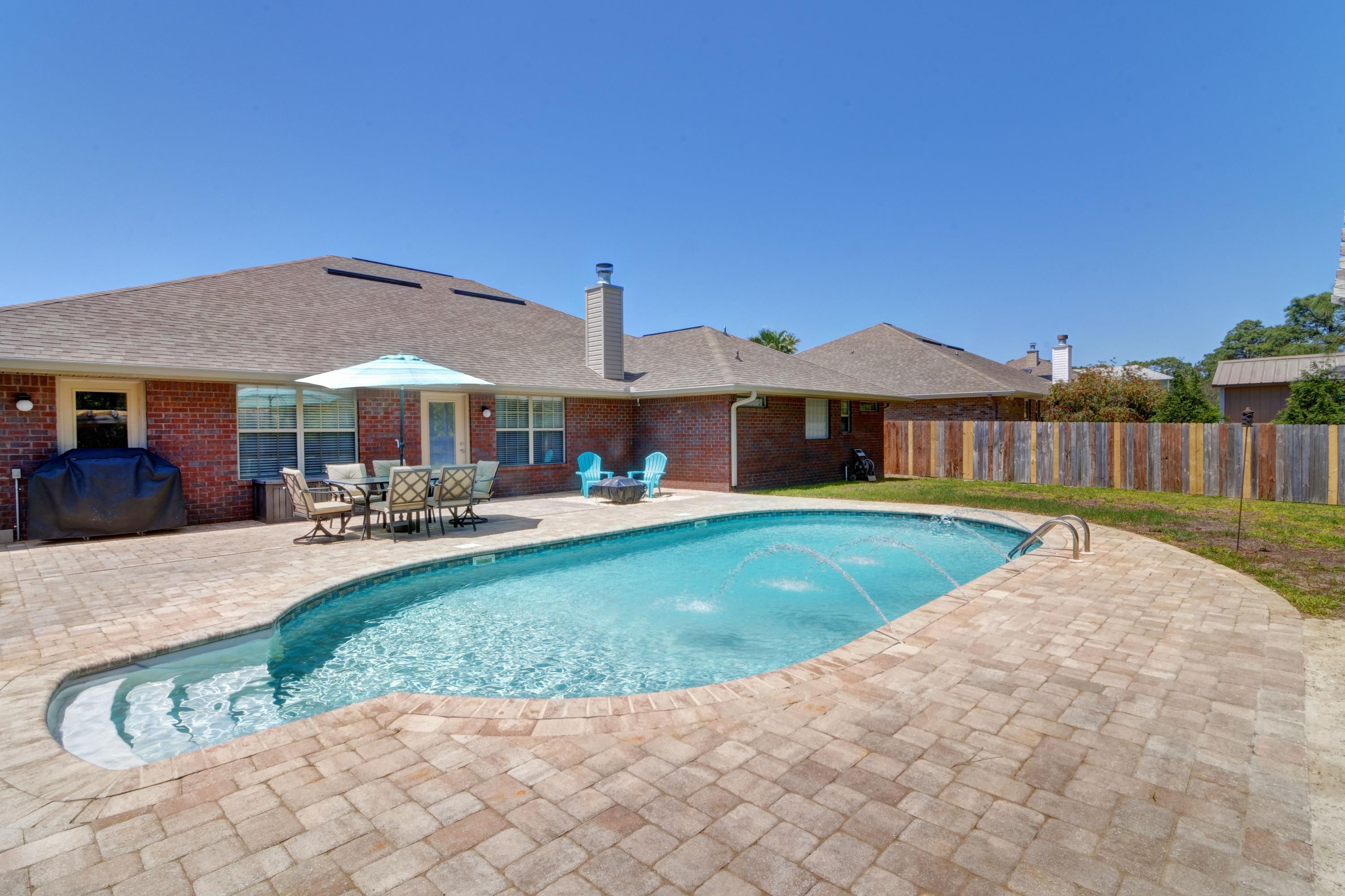 *POOL HOME* Welcome home to this stunning 4 bedroom/3 bathroom all brick beauty located in the popular and beautifully maintained neighborhood of Summerset Estates. Featuring over 3,000 sq ft of living space with a stunning backyard oasis complete with a salt water pool, custom pavers, a pergola covered sandy beach area, and firepit space all within a privacy fenced backyard (and no neighbors behind you!) this is the paradise you've been waiting for! Pull up the front driveway and appreciate the tasteful landscaping and lovely palms, and walk up to the custom glass front door where you'll enter inside and take in the oversized family room with cathedral ceiling as well as the beautiful stacked stone fireplace with a raised hearth and mantle. Looking for a large kitchen?