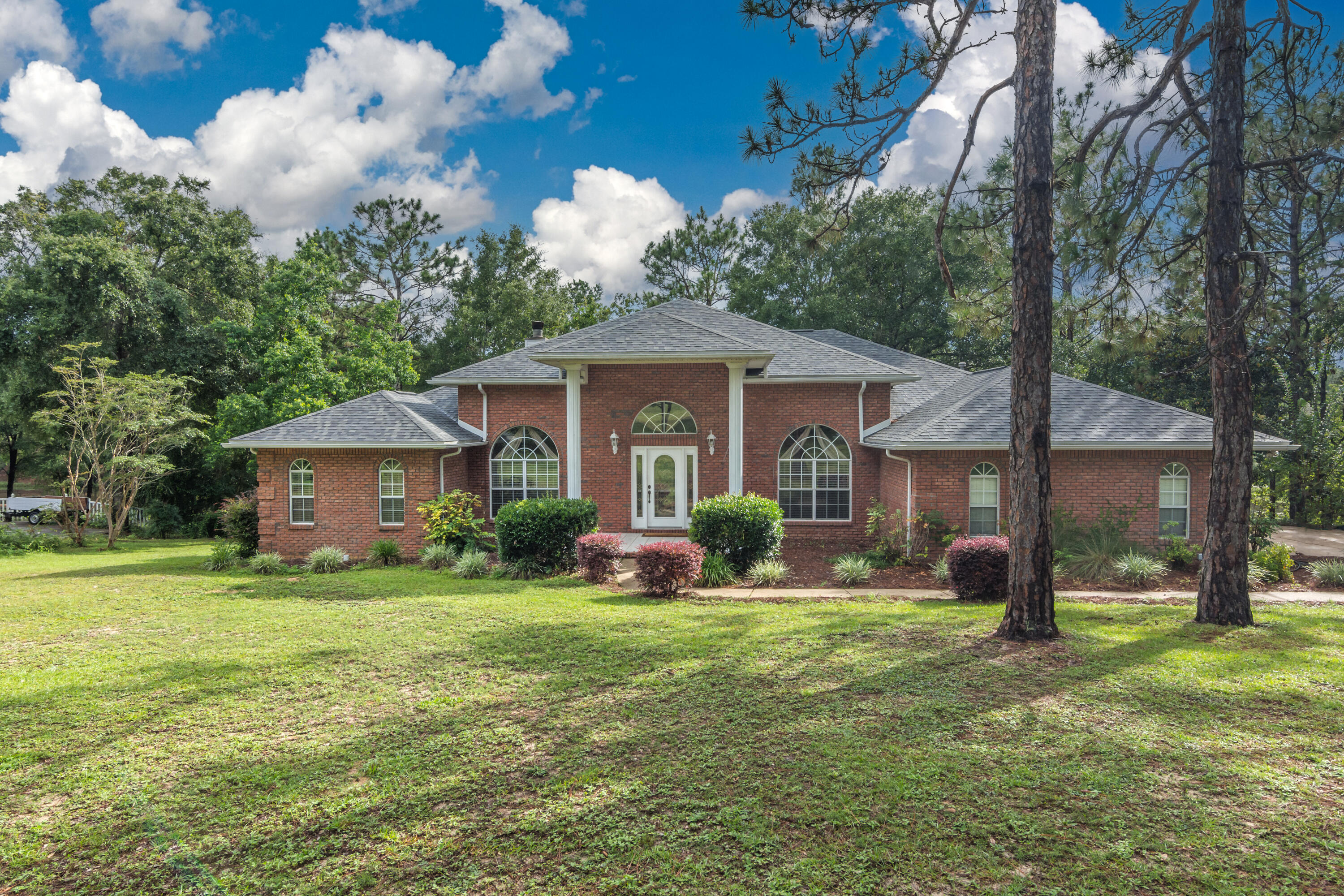 Rare find!!! Waterfront home on 1.04 acres with 160 ft. waterfront on a spring-fed lake. The 16 ft high front porch welcomes you with tiled floor with 16ft high aluminum columns. You will enter into an oversized Foyer with an open floor plan featuring 11ft ceilings and crown moulding in Foyer, Living room, Study, Kitchen, and Dining room. Living room has beautiful natural gas fireplace and triple sliding glass doors which open to a 10ft by 40ft tiled floor screened in porch that allows indoor/outdoor living. There are Tray ceilings in Study, Dining room, and Master bedroom. The kitchen has updated stainless steel appliances with a natural gas stove and electric oven with a warmer drawer, double drawer dishwasher and brand new refrigerator. The outside of the home features a new roof (2 1/2 years old) with 10 year warranty for any leaks with 30yr life dimensional shingles that is transferable to the new Buyer. The beautiful brick exterior is made of solid wood moulded bricks. The front house corners are accented by brick quoins. On the back of the house, there is 12ft by 24 ft deck with natural gas hookup for your grill. Come sit in your gazebo by the lake! Please note - Owners have never worn shoes in the home and require everyone that enter to kindly remove their shoes.
