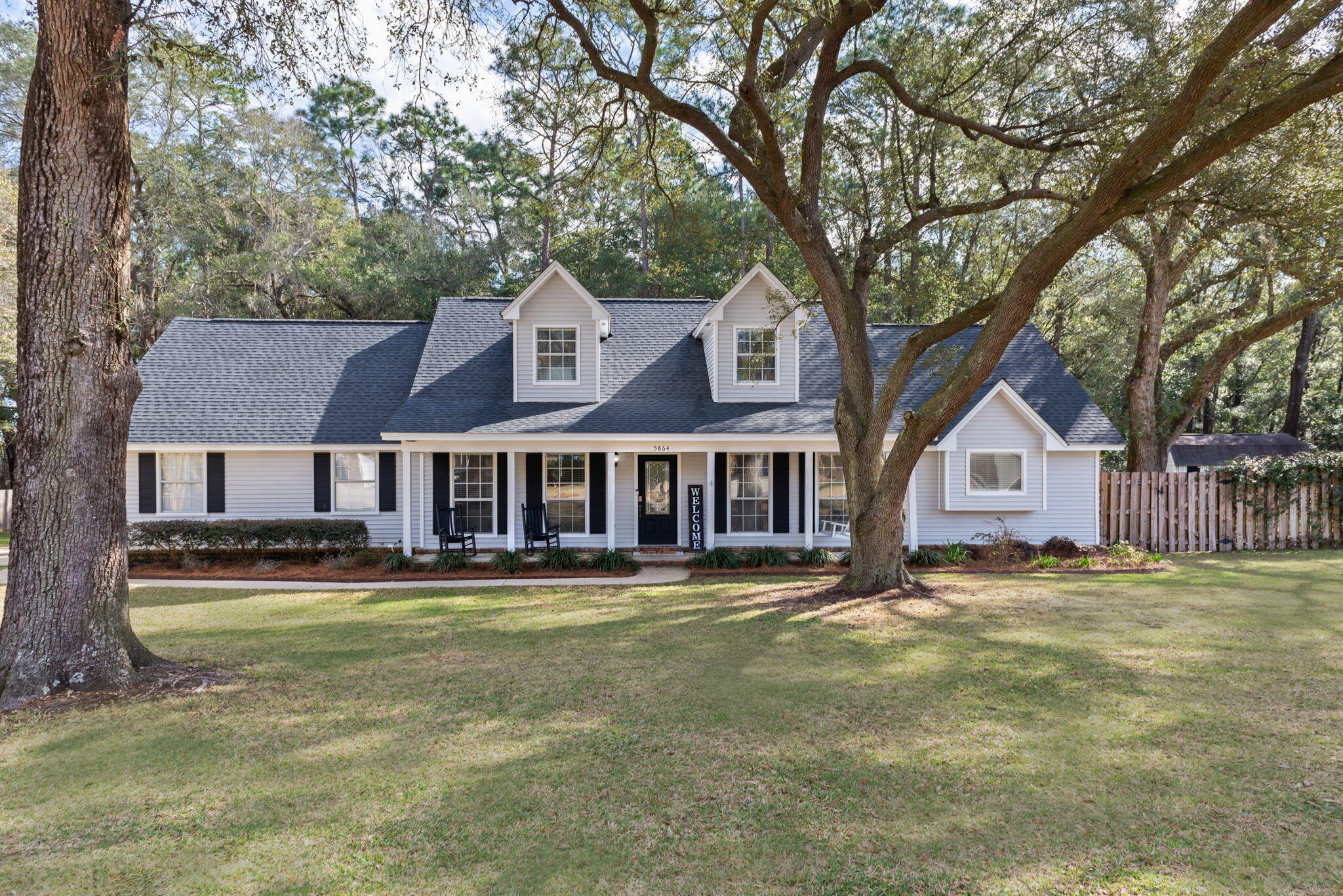 Golf Course Community! No HOA! Wonderful amenities are seen in this lovely southern traditional home that sets it apart from the rest! This country charmer represents a peaceful and inviting setting that boasts fantastic recent upgrades! Sitting amongst a large lot, you are overwhelmed by the picturesque setting as you are encompassed by mature trees and beautiful landscaping allowing you to appreciate nature while offering ultimate privacy. Set on almost an acre, this home offers an oversized driveway and sprawling manicured lawn before you are led to a convivial large front porch that is outlined by charming shutters and serves as perfect placement for rocking chairs and hanging planters while enjoying your morning coffee. Inside, you are greeted by a jovial tiled foyer that wonderfully transitions into two natural light filled rooms; formal dining area to the left and double doors on right leading to a large private office space that could also serve as fourth bedroom or secondary living space. Down the hallway you are led to the main living area that serves as the heart of the home where you'll find a floor to ceiling brick wood burning fireplace stylishly painted and chic wood mantel. Enjoy cool winters and cozy movie-nights while sitting around a warm tranquil fire. From the living room, you are led to the large open gourmet kitchen with many upgrades! You'll find an abundant surround of white newly painted cabinetry complimented with bronze pulls/hardware and new neutral Formica countertops. All new stainless-steel appliances, new ceiling and cabinet lighting, built-in mini fridge, sizeable attractive white farmhouse sink, and separate pantry. The spaciousness makes cooking a breeze and a desirable space for a butcher block island. The kitchen is completed with a eat-in breakfast nook sitting upon a large bay window. Through the kitchen, you are led to the hallway containing a convenient half bath, access to the backyard and two car garage, and a considerable separate laundry room with great storage space. Opposite the home on first floor, you will access the primary owners suite containing a large naturally lit room with large windows and new oversized ceiling fan. The adjacent master ensuite is most accommodating and features large double vanity, his and her closets, towel closet, large jacuzzi tub with tiled surround, and separate enclosed shower. Upstairs you will find the remaining two bedrooms making this a perfect distinct space for extended guests or additional family members. Each room is oversized and can accommodate large furniture, substantial closets, and both have a cute nook area overlooking the front lawn that would be great for a desk or window seat. There is a full guest bathroom between featuring a large vanity and enclosed shower/bath combo. The backyard will make all your dreams come true as it aids the perfect oasis for all your needs! From the rear of home, is an adjoining screened in lanai with ceiling fan that is already wired for an outdoor TV and the perfect location to converse and relax. The expansive backyard features a sparkling inground pool with large concrete surround and comfortable newly built outdoor firepit all in fertile surroundings. There is a substantial shed and lawn for grilling/activities to enjoy the best of the outdoors in a fully fenced private space oversaw by tall pines. Take the worry out of the upgrades with a NEW ROOF, NEW HOT WATER HEATER, NEW HVAC! Yard building in back does not convey. Call today for a private tour of this fantastic home!