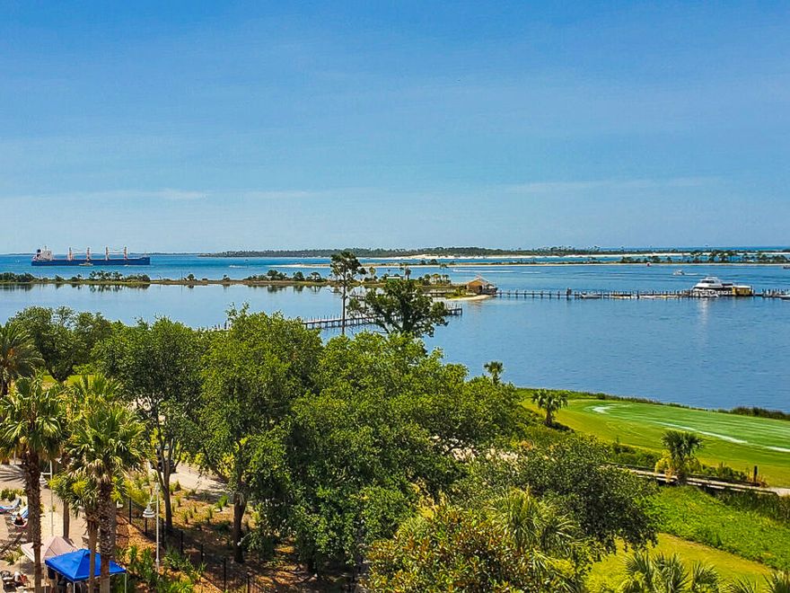 This Grand Residence at Bay Point offers beautiful views of St Andrews Bay & Grand Lagoon! This is a 2BR/2BA unit with a bonus room that would make a great home office, den or even a guest bedroom. All new flooring throughout.  Newly renovated kitchen with quartz countertops, stone, backsplash and shiplap peninsula island.  The private balcony can be accessed from both the living area and the Master suite. There is a huge walk-in closet between the master bedroom and bath, and the en suite boasts double vanities, a garden tub, and a separate shower. There is a climate-controlled storage room on the same floor and this unit has an assigned parking space (#59). The amenities for this building are exceptional with a heated pool, a hot tub,