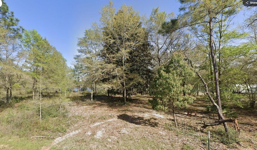 Rare waterfront homesite on a 5± acre pond offering flexible use and long-term investment potential. Mobile homes are permitted, creating an accessible path for affordable housing or future rental use (buyer to verify). Peaceful water views with a convenient location just minutes from downtown, shopping, and major services. An attractive option for owner-occupants or investors seeking a lower-cost entry point with potential income appeal. Priced to sell.