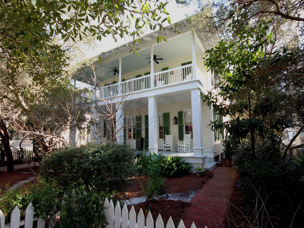 Located on Seaside's grand boulevard lined with an array of stately plantation style homes. The original home and guest quarters designed by Richard Gibbs for his personal residence while he was Seaside's town architect. The house was later expanded to accommodate the current family. The original design by Richard was preserved during the design phase. The front porches span the width of the home and expand the living and dining areas to the outdoors by three sets of French doors. A brick fireplace opens from living through to kitchen for all to enjoy. Kitchen was updated with custom made cabinets, marble countertops, Viking and Subzero appliances, 4 burner gas stove and expanded with a spacious butler's pantry. Laundry and half bath tucked behind kitchen. Con't