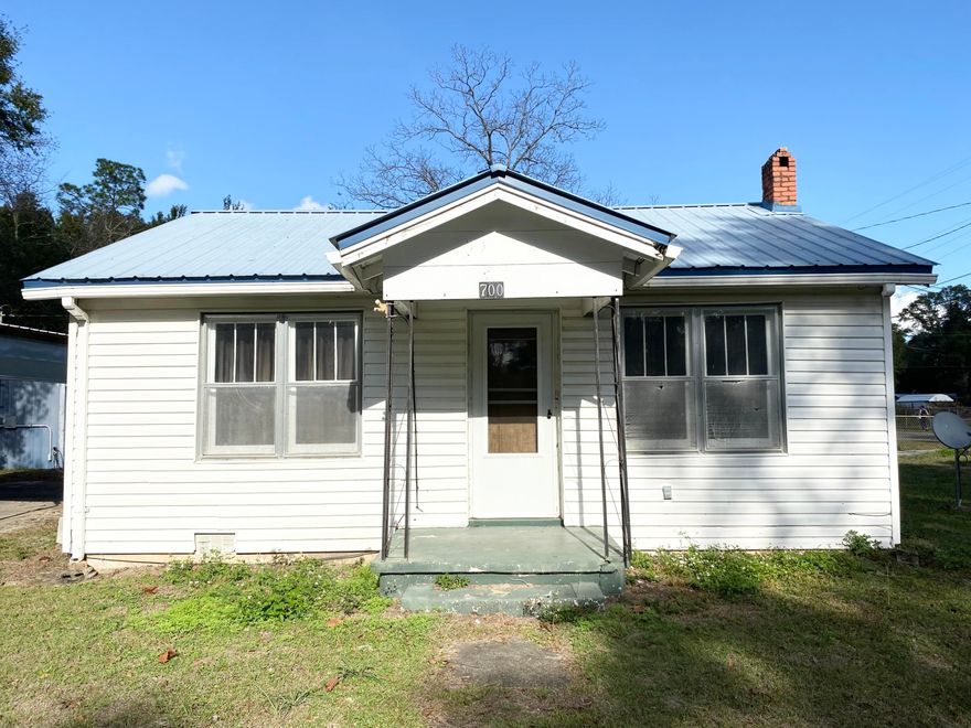 SELLER FINANCING AVAILABLE. For sale in the city limits of Defuniak Springs. The main house is 848 sq ft. With 2 bedrooms & 1 full bath. This quaint little home is ready for someone to make it what it's meant to be. Some cosmetic work has been started but needs some finishing touches. There are real hard wood floors in both bedrooms!!! The exterior of the home is finished in vinyl siding & a metal roof. There is a large detached carport (15X19.5) & a metal storage shed (9.5X13). The paved driveway & chainlink fence around the whole .78 of an acre are also an added bonus. AND the detached 624 sq ft GARAGE..... has a one car garage space & then a separate closed in living space with full bathroom. Use this space as your own or for extra cash as a short term rental.