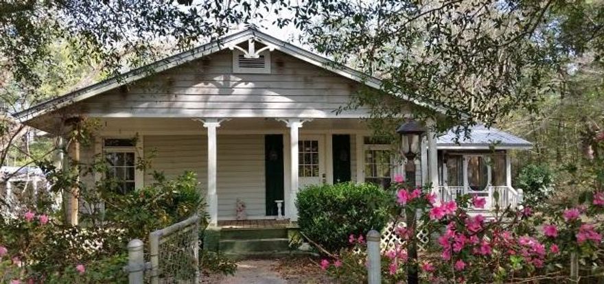 REO SITS ON TW0 PLUS ACRES AMONG HUGE OAKS, MAGNOLIAS, PECANS AND PINES. ''COTTAGE CUTE'' WITH TONS OF SHRUBS, FLOWERING PLANTS, TREES, (FIGS, KUMQUATS, PEARS, GRAPEVINES, BLUEBERRIES, ROSE AND HERB GARDENS) ETC ADDED TO SET THE STAGE FOR A COMFORTABLE LIFESTYLE AWAY FROM THE HUSTLE AND BUSTLE. LARGE POLE BARN WITH ELECTRIC FOR COVERED PARKING-WILL ACCOMMODATE 3 CARS PLUS THE BOAT AND MORE. LARGE SCREENED CATHEDRAL PORCH HAS FRENCH DOORS TO ACCESS THE KITCHEN AND DINING ROOM. CAPTURE SOUTHERN BREEZES WHILE YOU RELAX WITH YOUR ICED TEA AND ENJOY THE TREES AND FLOWERS. KITCHEN COMES WITH BREAKFAST BAR, TILED COUNTERTOPS, ELECTRIC RANGE, PANTRY AND VERY CHARMING ''FARM SINK.'' . DOORS AND WINDOWS(THERMAL,INSULATED, EASY TO CLEAN THE RARE ''HEART-OF-PINE'' FLOORING,ENJOY CONVENIENT I-10 ACCESS