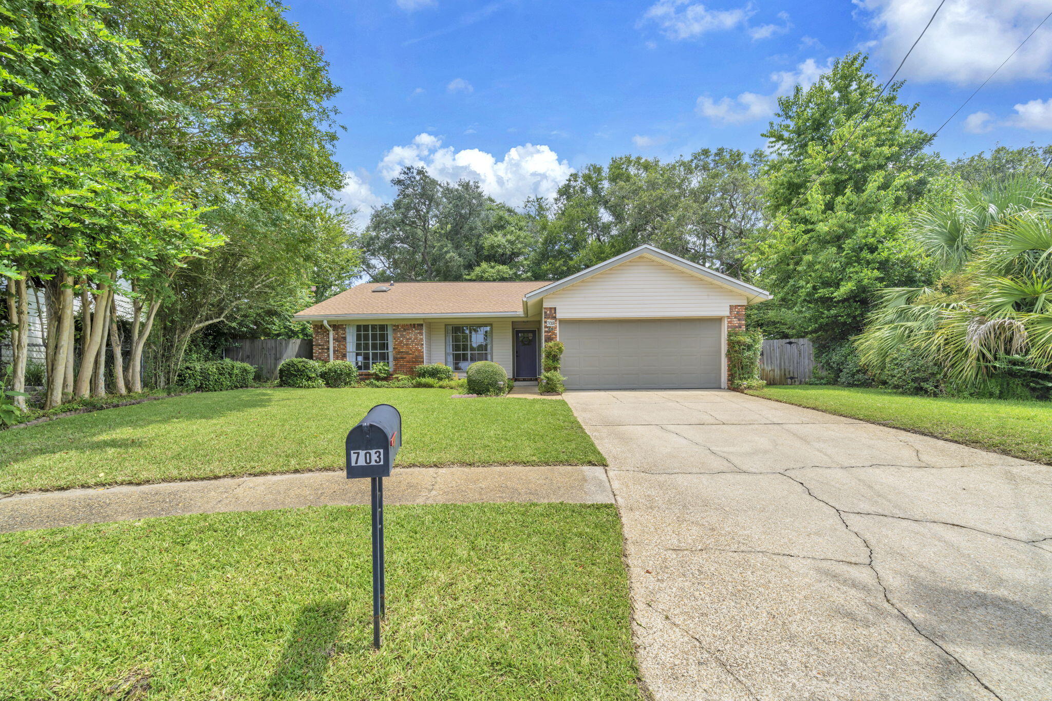 Assumable VA Loan! Beautiful, well-maintained home close to the military bases, great schools, and the white sandy beaches of Fort Walton Beach, FL! This 3 bedroom and 2 bath home with 1620 sq feet sits on a .27 acre lot! This lot is GOREGEOUS with the backyard resembling an oasis!! Roof replaced in 2022, HVAC replaced (2023) and hot water heater replaced (2024)! HVAC ducts cleaned (2025). The home has a long driveway for extra parking! There is no HOA and this home does NOT require flood insurance! Enter the home from the covered front patio into a grand living room with vaulted, 12 foot ceilings. The ceilings have shiplap with a center beam and ceiling fan! The living room also features a wood burning fireplace with a mantel. This room overlooks the incredible back yard and there is an exit onto a covered, screened patio! The living room opens to a dining room that could also be a home office or bonus room! The kitchen features an eat-in kitchen area, stainless and black dishwasher and microwave, white slide in smooth cooktop and oven and a side by side refrigerator with icemaker. The kitchen has windows that overlook the large, fenced back yard and there is plenty of natural light! The countertops have been updated as well as the lighting. The primary bedroom is large and features a beautiful view of the back yard! There is an updated ensuite primary bathroom and a large walk in closet with custom shelving. The primary bathroom and guest bathroom have some updates such as new faucets and fixtures. The primary bathroom has new tiled flooring and a tiled surround. The home features skylights, gutters on the front and back, a two car garage, and a shed. This home has been very well maintained and is move in ready! Buyer to verify all dimensions and information.