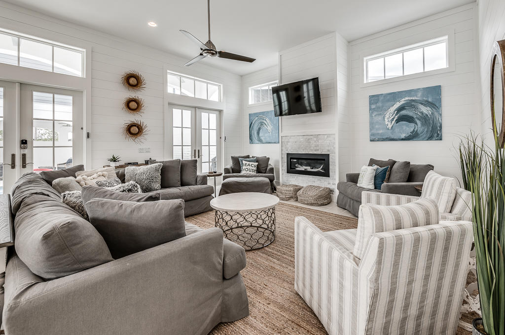 Built in 2019, this inviting beach retreat has all the marks of a quality residence: 12-foot ceilings with bright transom windows, travertine flooring, a beautiful gourmet kitchen with high-end stainless appliances, and private amenities. White shiplap walls in the main home provide a quintessential backdrop for the contemporary gas fireplace in the open-concept great room, while French doors lead out to a secluded courtyard with covered terrace. The private, heated pool provides a perfect space for leisurely afternoons and al fresco entertaining in all seasons, and there is plenty of space to further customize this outdoor oasis with a summer kitchen or fire pit. Five spacious suites are located in the main home with a luxurious master bedroom and spa on the first floor and four...