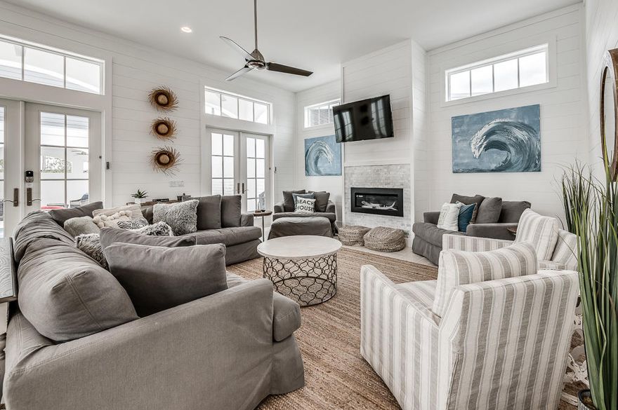 Built in 2019, this inviting beach retreat has all the marks of a quality residence: 12-foot ceilings with bright transom windows, travertine flooring, a beautiful gourmet kitchen with high-end stainless appliances, and private amenities. White shiplap walls in the main home provide a quintessential backdrop for the contemporary gas fireplace in the open-concept great room, while French doors lead out to a secluded courtyard with covered terrace. The private, heated pool provides a perfect space for leisurely afternoons and al fresco entertaining in all seasons, and there is plenty of space to further customize this outdoor oasis with a summer kitchen or fire pit. Five spacious suites are located in the main home with a luxurious master bedroom and spa on the first floor and four...