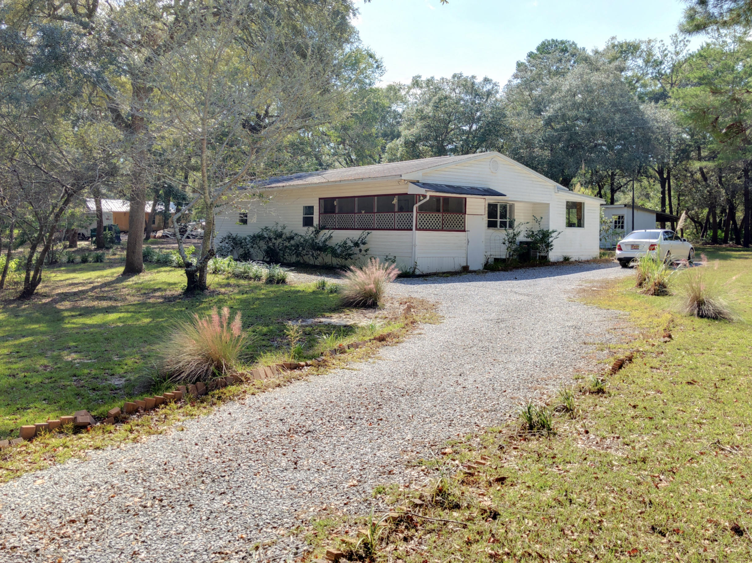 What a beautiful 1.6 acre 1,555 SqFt home! Located minutes from town and the new Publix shopping center. Buy this property as your next home or good rental potential!! Home is located just .1 mile from the Alaqua Bayou creek bridge. This area is surrounded by beautiful trees and private. Cash sale only.