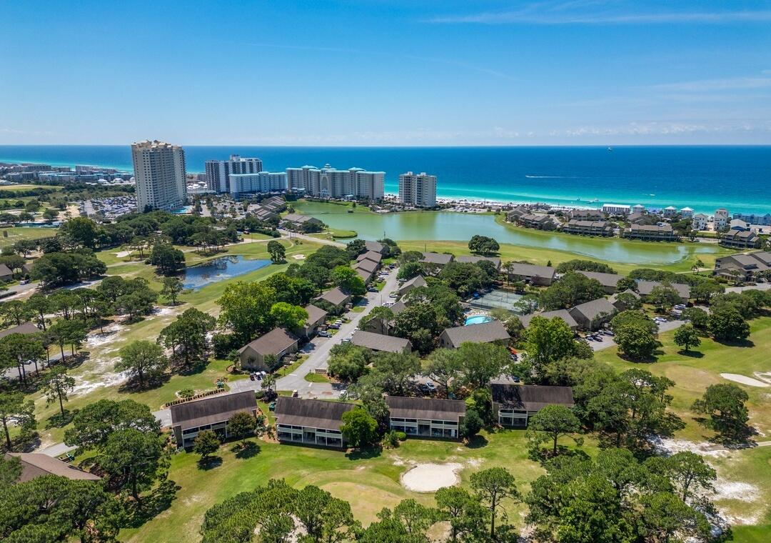 You Coastal Luxury in a Private, Gated Beachfront Community Indulge in the ultimate Emerald Coast lifestyle with this stunning 2BR/2BA retreat in the exclusive Golf Villas at Seascape Resort--a gated paradise offering 2,000 feet of private sugar-white sand and shimmering emerald waters. Just a short stroll to the boardwalk, this residence places you steps from the beach while surrounding you with world-class amenities: a championship golf course, sparkling pools, tennis courts, and the lively Seascape Towne Center.Inside, discover a beautifully renovated sanctuary designed for comfort and style. The chef's kitchen boasts sleek, new appliances, while the open-concept living area showcases designer furnishings and serene views of the lush fairways. Read more... Both bathrooms exude elegance with custom tile showers and refined finishes. The spacious king master suite, charming guest bedroom, and queen sleeper sofa provide accommodations for up to 6 guests. Your friends, family and vacationing guests will NEVER want to leave.
Savor your morning coffee or evening glass of wine from the private deck, where you can watch golfers against a backdrop of swaying palms. With easy parking, abundant storage, laundry room near your stairway, and every luxury at your fingertips - this unit is not just a condo - it's a coastal escape you'll want to return to again and again.