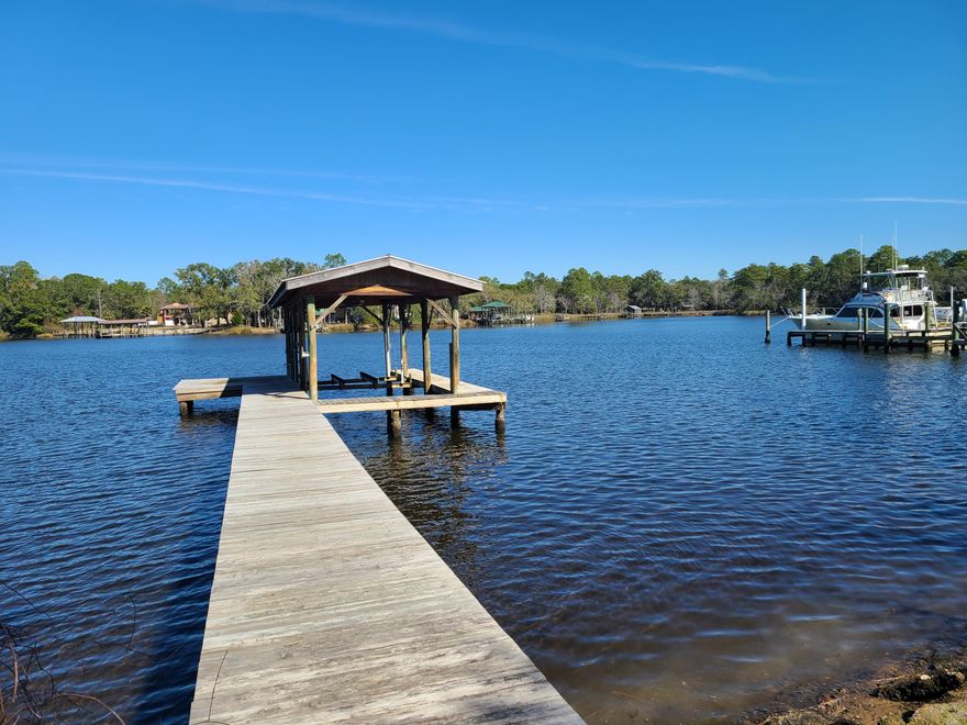 This 1.3 acre estate size waterfront property features 3000sf, 5 bedroom, 3 bath, 3 car garage, one-story home built in 1983, with bulkhead/seawall, rip-rap, and boat house with lift. The property is zoned 2 units per acre. The home is in good condition, but could use a little updating to make it the perfect home on the water. Majestic Oaks complete the upper story canopy with Azaleas adding a splash of color to the yard. Make an appointment to see this home!