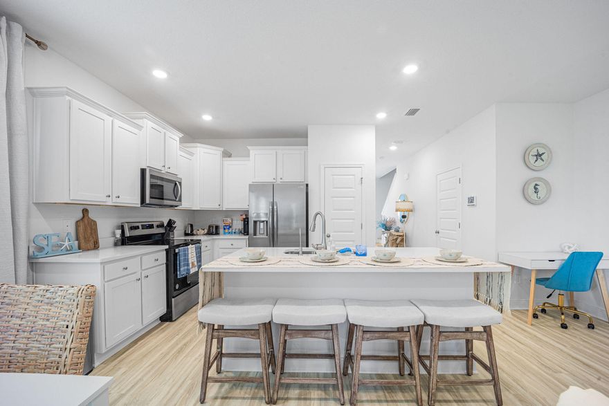 Fully furnished and move-in ready, this spacious end-unit townhome in Hawk's Landing is the largest and best-positioned in the community--offering flexible living just minutes from the beaches of 30A. Whether you're looking for a primary home, second home, or investment property, this 3BR/2.5BA checks all the boxes.The open layout is bright and inviting, thanks to extra windows, upgraded insulation, and thoughtful details throughout. The kitchen features upgraded quartz countertops (not standard in builder-grade units), a center island with a stainless sink, premium appliances, and crisp ivory cabinetry. Upstairs, all bedrooms are generously sized and come outfitted with Nectar hybrid mattresses and cozy UGG bedding. A dedicated workspace adds remote-work potential, while the private back patiowith an included Pit Boss smoker makes casual outdoor living a breeze.

This unit also includes epoxy-coated garage flooring and comes equipped with a washer and dryer, saving you even more compared to new construction. As a fully furnished, turn-key property with no immediate updates needed, it delivers low-maintenance comfort in a quiet, well-kept neighborhood close to Ed Walline Beach Access, Cessna Landing, and North Beach Social.