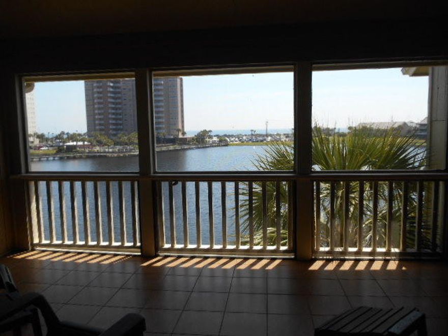 You will not be disappointed!! Beautiful Lakefront condo. Stewart Lake at its finest... What views-lake and Gulf!!! The kitchen has been completely remodeled-granite countertops, cherry cabinet, copper sink, Under counter lighting, just to name a few things. Two of the three bathrooms have been remodeled also. French doors open to the screened porches that have tile. Owners pride in ownership carries over to every part of this lovely condo. Unit is being sold furnished with a few exceptions of personal items. Buyer to verify square footage and any other information deemed important to them. There are 2 HOA fees, one is approx. $831.00 quarterly (Bldg. 7C fees) and the master Seascape policy is approx. $567.00 Quarterly. Special assessment of $350.00 quarterly until 5/2016.