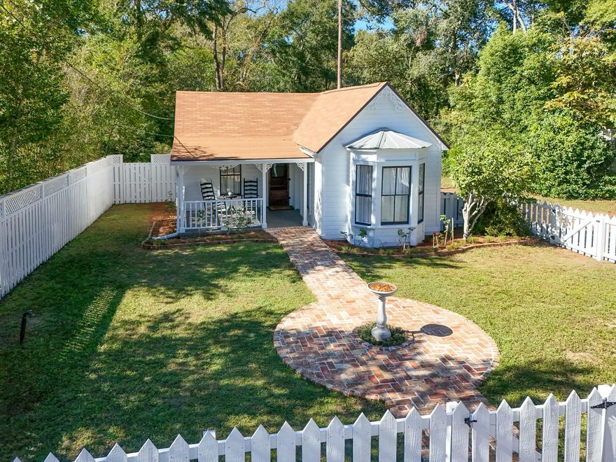 Back on the market through absolutely no fault of the seller! 'All I want is a sweet little one story cottage near Lake DeFuniak that doesn't need any work.' Your wish is our command! This quintessential Florida cottage is located in the historic district, a short stroll to Lake DeFuniak and downtown, with 3 beds/1.5 baths and 1339sf all on one level.  Every detail of this historic sanctuary has been thoughtfully restored. Nothing has been left to do. Every board is caulked and painted inside and out. All electrical and plumbing? Done. Refinished floors? Check. The galley style kitchen with quartz counters, original brick fireplace stack, and vintage-inspired finishes leads to the calming sunroom. The perfect space for morning coffee or afternoon relaxation, featuring a half bath and convenient laundry area. The new master bath is the epitome of timeless materials combined with modern fixtures, featuring an original clawfoot soaking tub and large tile and glass shower. This home has all the magic you'd hope for in a properly restored historic home. Speaking of history, while the tax rolls say otherwise, the sellers have evidence that the year built is actually 1876 and originally served as the first Methodist Episcopal Church building. There's also a storage building/workshop, all sitting on nearly 3/4 of an acre; an unheard of lot size in the historic district! The front walkway was recently designed and crafted with antique Chicago brick, creating an inviting hello and a warm sending off in style. I challenge you to find a more enchanting, finely finished home in the downtown area. With an acceptable full price offer, the sellers will include the carefully selected furnishings to make it a perfect package.