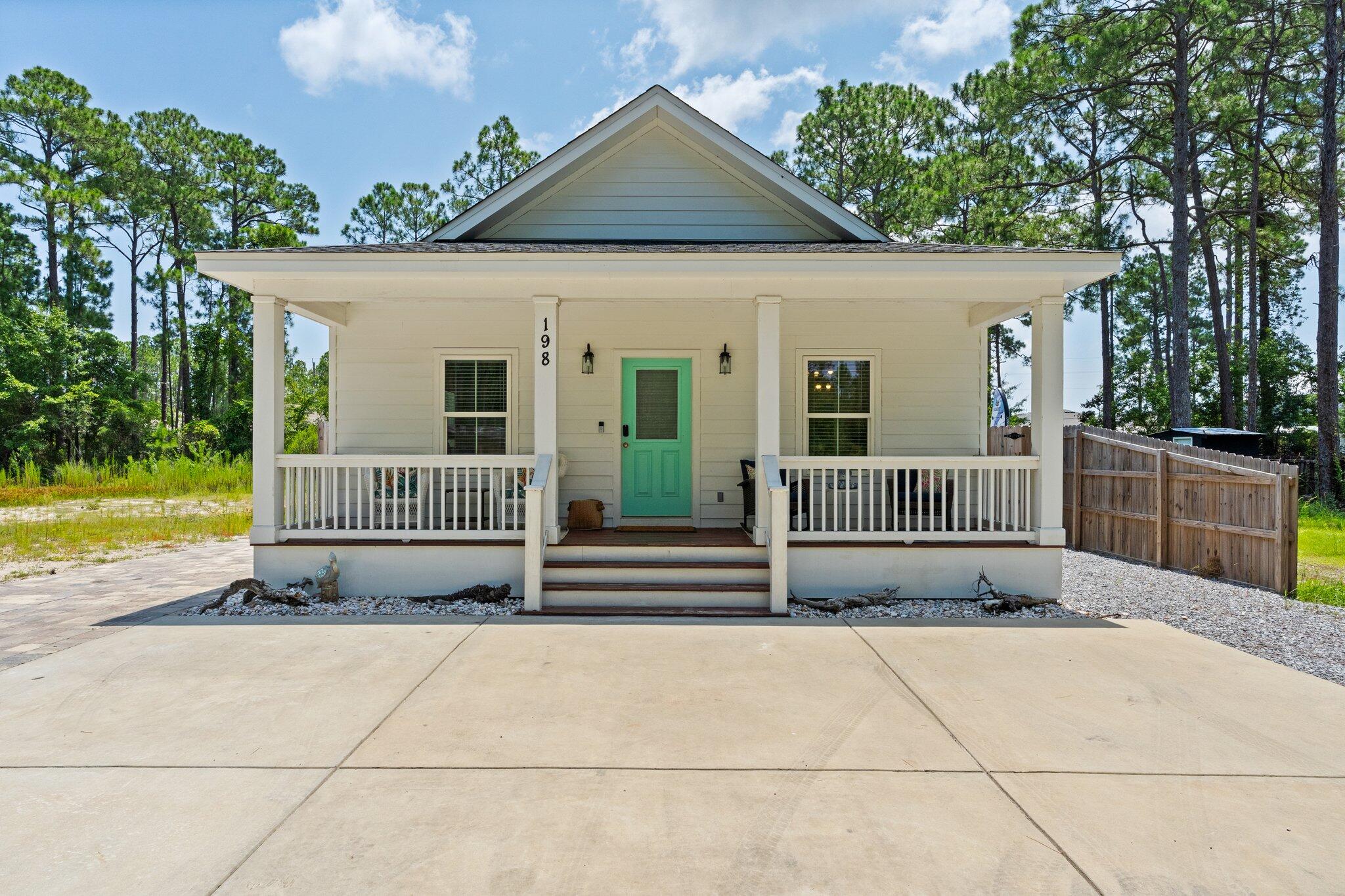 Welcome to 198 1st St. This high quality 3BR/2BA home is beautifully maintained & being sold fully furnished & well equipped...making it ideal as a vacation rental, second home, investment property, or full-time residence. Currently operating as a successful short-term rental, the home features tasteful coastal decor, hardwood floors throughout & a modern kitchen with stainless steel appliances, quartz countertops & beautiful tile backsplash. Enjoy the Florida lifestyle with three spacious porches, perfect for coffee, cocktails, or catching a breeze. Out back, unwind in your own private oasis complete with a tiki bar, lounge area & hot tub. The no-maintenance yard is fully paved and accented with coastal shell landscaping, giving it a clean, beachy vibe with zero hassle. Other highlights include ample parking for guests, boats, or multiple vehicles, no HOA, and an X flood zone location, meaning no flood insurance is required. Located less than a mile from Cessna Landing Park with public boat ramp access & just minutes to Ed Walline Beach Access at Gulf Place, you'll have quick access to both the bay and the Gulf. Whether you're looking for your own personal retreat or a smart, income-producing investment, this home delivers on all fronts: turnkey, stylish, no restrictions & packed with potential. Don't miss your opportunity to make this rare gem yours!