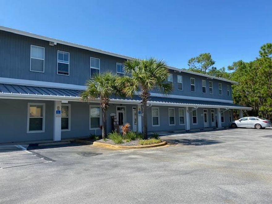 Impressive & unique commercial space in the heart of Miramar Beach. Located in the popular South Holiday Business Center, this desirable location is just  one block away from the highly traveled Highway 98 and 3 short blocks from the beach.Easily accessible with a traffic light at the corner of Hwy 98 and S Holiday Rd.(CVS on the corner) This unit is comprised of two generously sized floors with 1,175 sf each.A convenient rear service entrance,combined with an attached garage/warehouse area for ample storage makes this a one of a kind space that can accommodate many different business platforms including 2 different businesses.Front entryway foyer has a separate door for the downstairs unit & staircase to the separate upstairs unit w/ full bath and kitchenette. Zoned VMU. Plenty of parking