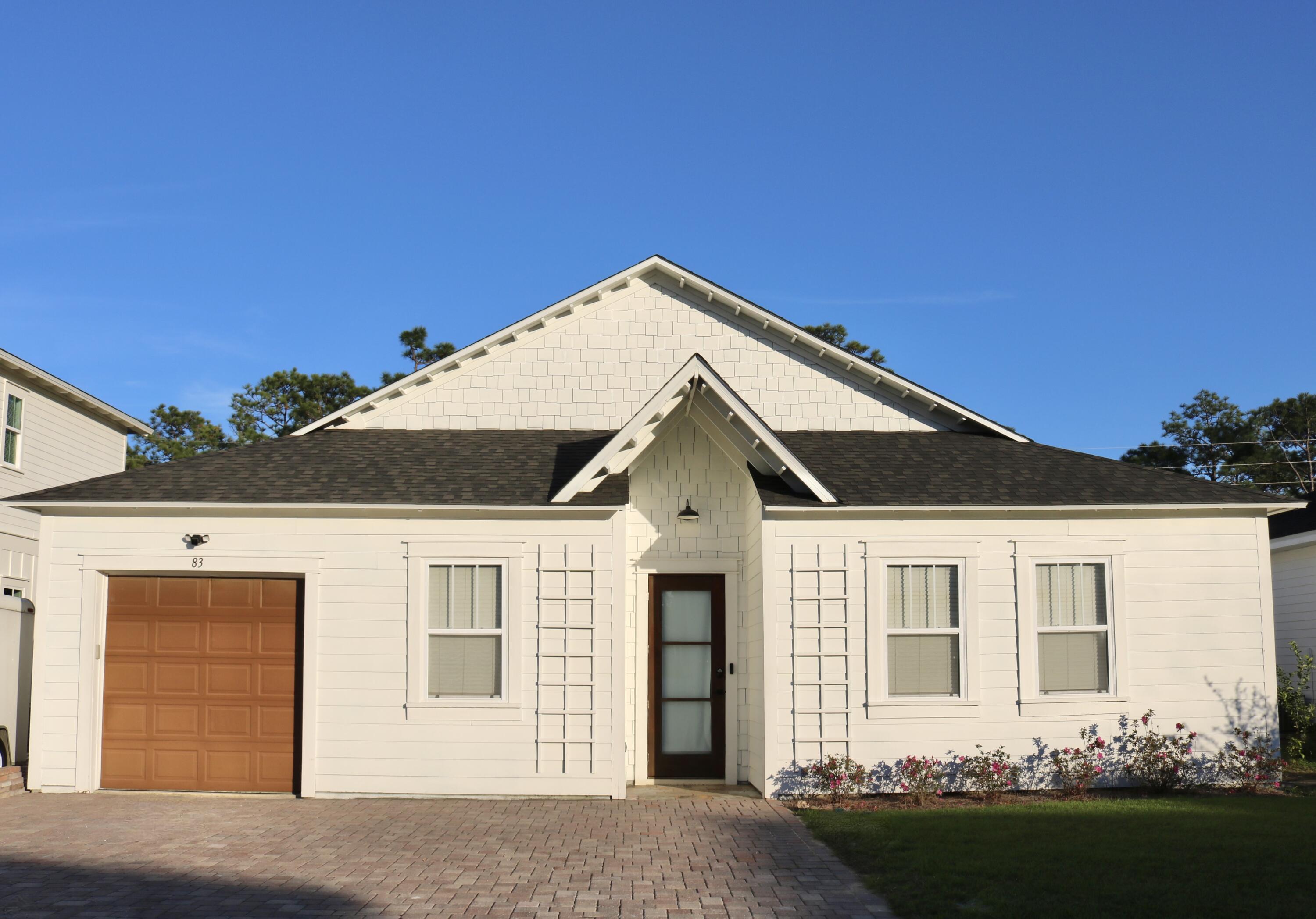 Discover this delightful 3 bedroom, 2.5 bathroom home, offering 1,535 square feet of thoughtfully designed living space. This property has been updated with unique finishes throughout. The exterior of the home has a newly installed paver driveway, and a new roof installed in 2024. Inside, natural light pours into the main living space featuring 10' tall glass panes along the back of the living space. The open concept layout seamlessly connects the living, dining, and kitchen areas. Updates throughout the home include LVP flooring, tiled master bath shower with rain shower head, tiled guest bathroom shower/bath combo, back yard putting green, and new paint on the interior and exterior of the home. Conveniently located in a quaint neighborhood with easy access to 98!