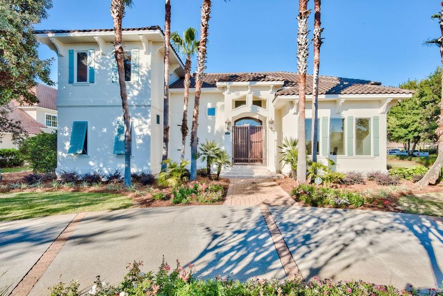 Elegant and inspiring, this two story home is situated on a large corner lot tucked in the exclusive gated community at Kelly Plantation. A circle driveway and three-car garage provide plenty of parking for family and friends, while lush landscaping makes this home feel serene and inviting from the moment you arrive. The front door opens to bright and open living areas with sophisticated finishes. A spacious living room showcases travertine flooring, 15-foot coffered ceilings, and a wall of windows that overlook a beautiful backyard oasis. Located just off the living room, the gourmet kitchen and family room feature high ceilings with wood beams and hardwood oak flooring. The kitchen contains high-end appliances, ample storage space, and two islands, one of which offers room