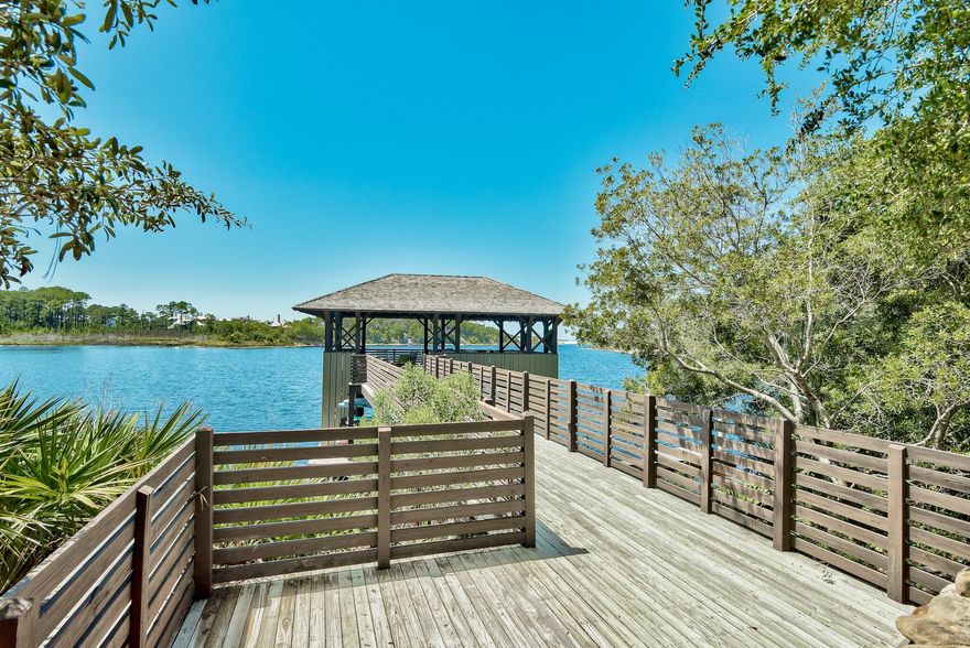 Pride of ownership and attention to detail is captivated in this custom gulf view Draper Lake beauty! A stunning staircase and elevator add convenience to this thoughtfully designed reverse living layout. The expansive windows throughout enhance the coastal dune lake/gulf views. Perfectly blending the indoor/outdoor lifestyle, Euro doors open to the front balcony while a large side covered porch with outdoor kitchen, fireplace and TV is the perfect place to enjoy sunset skies in a tree house setting. Unique to the property is ample parking, including a 2-car garage with a long drive to accommodate multiple cars; a fenced yard; enhanced privacy as the home is next to a walking path to the beach; and plenty of space with 3891 sq. ft. Inside the home radiates with natural light and the expansive wood raised beam ceilings showcase the rare coastal dune lake and gulf views. The gorgeous kitchen has marble counters and backsplash with custom white oak cabinetry and an incredible butler's pantry with plenty of storage. Throughout the home you will find custom cabinetry with tons of storage, marble and hand-cut mosaic tile, designer lighting and beautiful furnishings, a whole house water filtration system, surround sound system, and artwork by a renowned 30A artist.

Enter the home through a grand front porch into a beautiful foyer flanked by two bedrooms with ensuite baths. A second foyer introduces an elevator, a suspended staircase with a stone wall, designer windows, and stunning light fixtures. Additionally, on the first level, there is a large home gym and office (either could be converted into a bedroom), craft room, full bath, laundry room, and mud area with storage leading to the fenced backyard and to the 2-car garage. A gas fireplace adorns the large side porch, connected to the upper porch and carriage house by a staircase.

Ascend to the upper level to discover a captivating open floor plan with warm wood ceilings, a gas fireplace, and breathtaking views. The incredible butler's pantry includes tons of storage and glass-fronted curio cabinets. Down the hall is a primary bedroom with an en suite marble bath and large master closets. Step from the living area onto the front balcony through elegant Euro doors, or choose the intimate charm of the covered porch with its own fireplace and outdoor kitchen. Continue along a catwalk to the carriage house, a private retreat encompassing a comfortable living area, kitchenette, a full bath, and a bedroom.

The sought-after gated community of Draper Lake offers all the amenities for the outdoor enthusiast. Take a walk along the lake, over bridges, and through the natural setting on the neighborhood hiking trails. Stop for a view of the lake/gulf at the observation area or boathouses. Grab your paddle board or kayak at the boat house and paddle to the beach. Take your pets/children to play in one of two grass parks or at the beach pavilion. Take a swim at one of two pools. Climb the lookout tower to enjoy ocean and lake views. Enjoy the peace and quiet, as Draper Lake is a rental-restricted community.

Explore the unparalleled offerings of 86 W Cedar Bend Rd.! The home is sold fully furnished and ready for your enjoyment. While all information is believed to be correct, verification is recommended. An extraordinary lifestyle awaits!