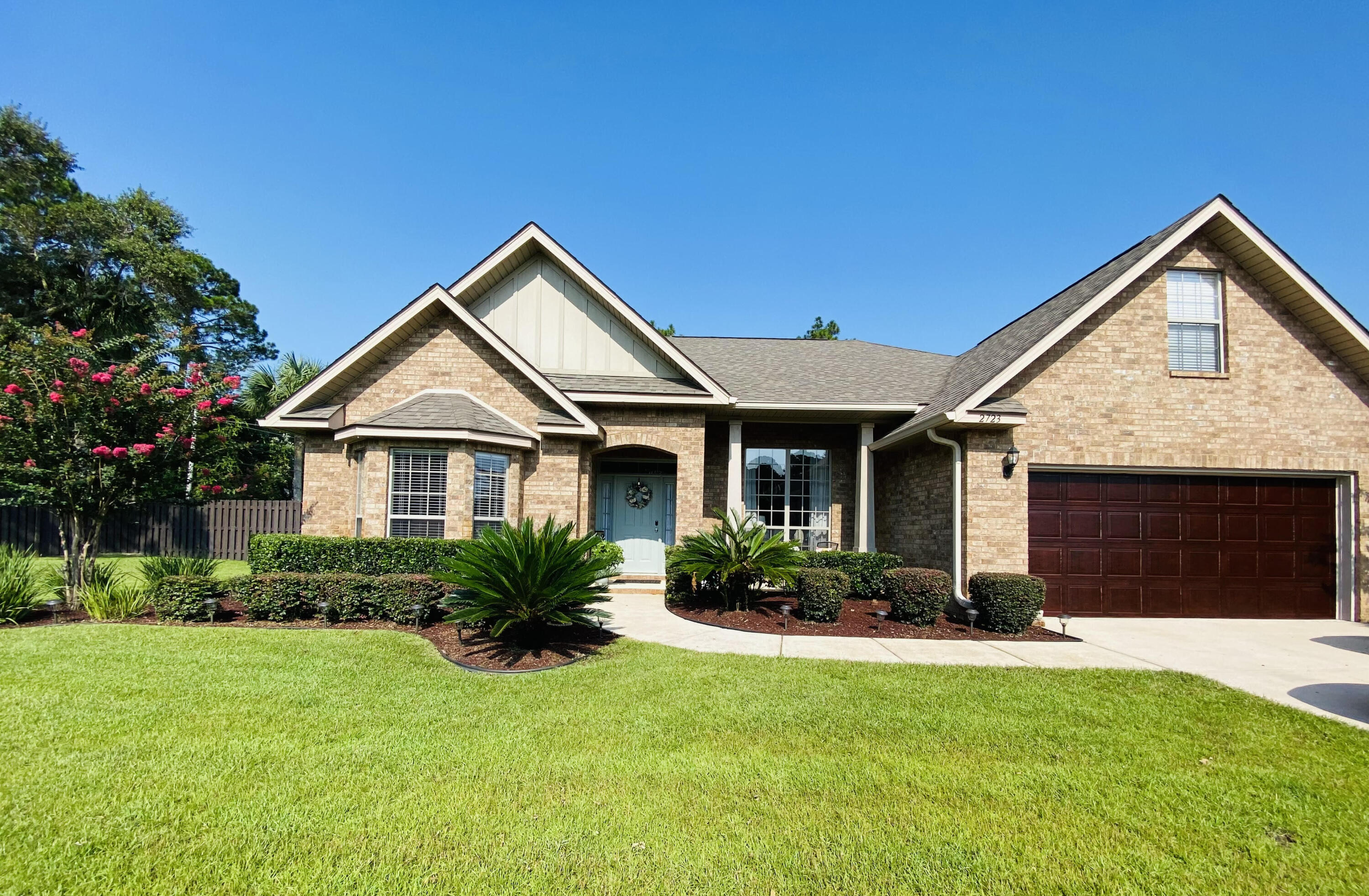 Welcome to your new home in the highly sought after community of Grand Bay Estates. This captivating family neighborhood, located minutes from Navarre Beach, has sidewalks, street lamps and resident access to the East Bay for fishing, kayaking, or relaxing on the community pier. This impeccable smart home features 4 bed/2 bath, dining room, office, laundry and a 2 car garage. Rich hardwood floors adorning the foyer, living room, dining room, and through the French doors leading to the private office. The spacious living room features a vaulted ceiling and beautiful stone wood burning fireplace for winter evenings. The large kitchen is equipped with stainless steel appliances, touch faucet, and generous 36'' Shaker cabinets with dimmable under-cabinet LED. Schedule your showing soon!