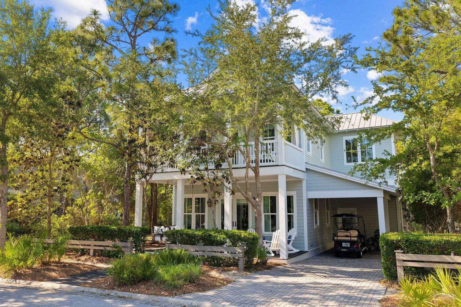 Basking in gently dappled shade, this southern-style Florida cottage is ideal for outdoor living within the prestigious enclave of WaterColor. The shady front porch is made for lazy afternoons on the swing seat, reading or relaxing with family and friends. Double doors open into an impeccable sitting room with gorgeous hardwood floors and multiple windows introducing abundant natural light. There's a generous dining area and a wet bar for entertaining. Move toward the open kitchen and run your hands over the cool island countertop. Hop onto one of the bar stools and chat with the cook while sipping perfectly chilled wine from the under-counter fridge. The well-appointed kitchen boasts a full range of pristine white cabinets and high-end stainless appliances. As well as the traditional front porch, this home has an elegant screened living space to the rear. Rustic floorboards and exposed beams add character to this homely outdoor space as you relax around the fireplace watching TV. For a true alfresco dining experience, there's a patio for dining and entertaining in tranquil surroundings. Rinse off sandy feet in the outdoor shower after a stroll on the nearby beach. Four bedrooms include a spacious first-floor bedroom with a huge bathroom with shower and tub. At the top of the stairs, there's a landing with a sitting area and a curtained bunk recess for young guests. The master suite has beautiful window treatments and access to the second-floor porch. The master bathroom is equally well-appointed with a twin vanity, enclosed shower and whirlpool tub. Never rented out, this immaculate home has been lovingly cared for, right down to the finest detail. Notable updates include the well-appointed first-floor master suite and an updated laundry and half bath. There's a side carport for your golf cart and parking for two vehicles on the paved driveway. The WaterColor community has outstanding amenities including several pools, tennis and pickleball courts and an exclusive Beach Club. A lazy river winds its way through Camp WaterColor and if you enjoy kayaking or paddleboarding on Western Lake, the boathouse is fully stocked with everything you need. With shopping and dining nearby, there's something for everyone to enjoy.