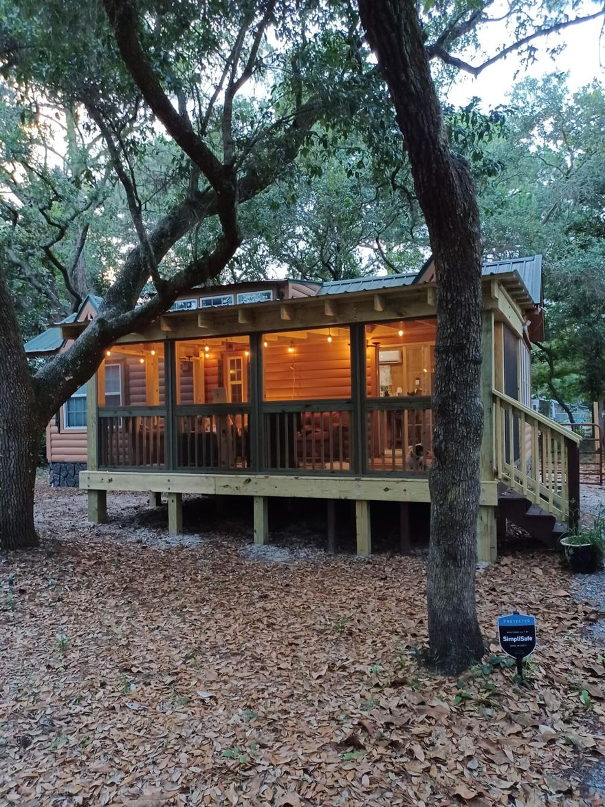 Discover your cozy retreat in this delightful 551 sq ft tiny home nestled in the serene woods of Santa Rosa Beach. Perfect as a personal getaway or a unique investment opportunity.Features:- 1 Bedroom: Comfortable and inviting space.- Loft: Ideal for extra sleeping space or storage.- Full Bathroom: Modern and well-appointed.- Living Room: Bright, welcoming, with vaulted ceilings.- Kitchen: Efficient with ample storage.- Screened-In Porch: Enjoy the outdoors without the bugs.- Rustic Charm: Wood exterior and green metal roof blend with nature.Interior Highlights:- All-wood design with natural wood paneling.- Large windows for abundant natural light.- Ceiling fan for added comfort.Set on a wooded lot, this home offers privacy and a peaceful atmosphere.
