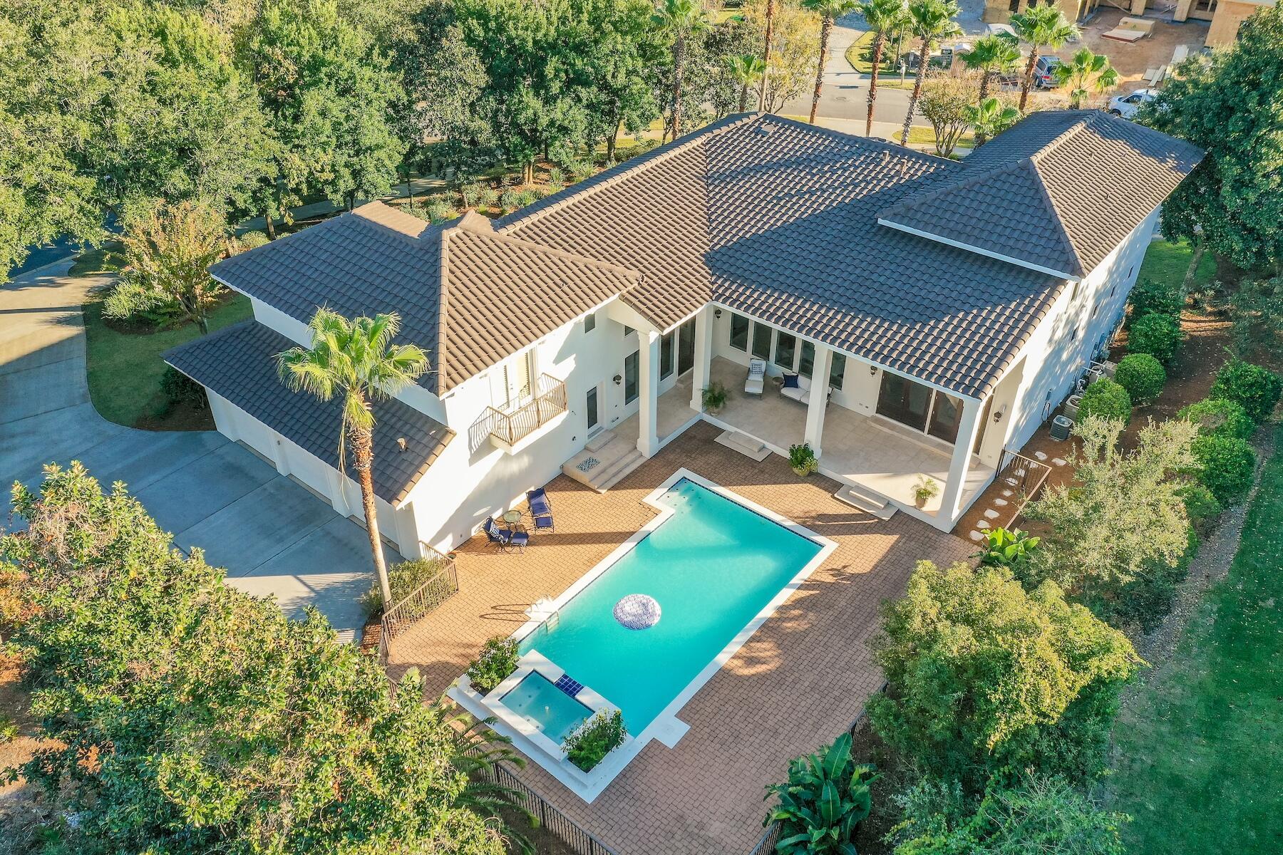 This freshly renovated two-story home is located on a spacious corner lot within the gated community of Kelly Plantation. The property offers a luxurious and inviting atmosphere with numerous modern upgrades and amenities.Upon entering through the front door, you are greeted by a bright and open living room adorned with travertine flooring, 15-foot coffered ceilings, and large windows that overlook the backyard oasis and private pool, which sparkles in the sunlight. The living room seamlessly flows into the new gourmet kitchen and family room, featuring high, wood-beamed ceilings and hardwood oak flooring, creating an elegant and cozy space. The recently replaced gourmet kitchen is a chef's dream, equipped with high-end appliances, imported cabinetry, stunning quartz countertops,