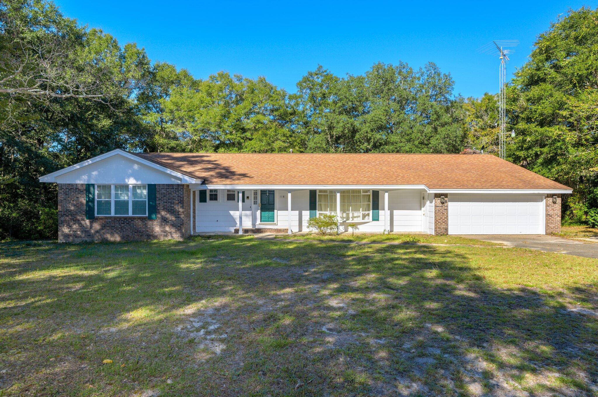 Almost an acre in Niceville! This 4/2.5 home is located in Rocky Bayou Estates on a .85 acre lot! As you enter this home, you are greeted into the one of the two generously sized living rooms. This home features a formal dining room with large bay window and built in cabinetry as well as an additional an additional breakfast nook. The kitchen offers plenty of cabinet space and overlooks the secondary living space that boasts a stunning wood burning fire place. All bedrooms, including the master suite, are quite spacious. Head out back and prepare to be amazed. Sit on the back deck area and enjoy the serene views overlooking a massive backyard and workshop. Schedule your showing today!